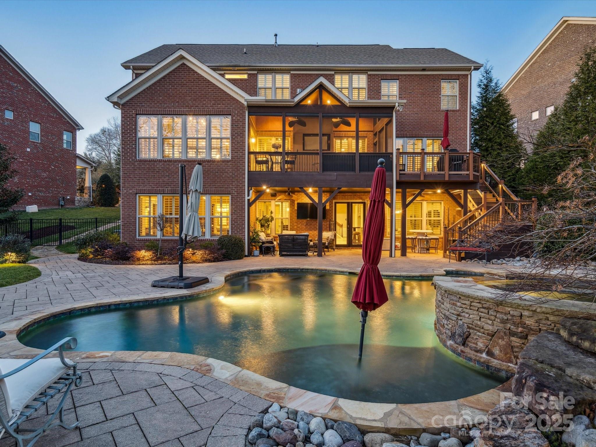 Discover luxury living in the desirable Barber Rock neighborhood. This elegant home offers a 2-story layout w/ a fully finished basement, ideal for modern living and entertaining. Thoughtful upgrades include a whole-home water filtration system, plantation shutters throughout & each HVAC unit is equipped with a UV air scrubber. The main level features a primary suite, gourmet kitchen with a large island, walk-in pantry, great room w/ a gas fireplace & formal dining area. Upstairs, find 4 bedrooms, 3 full baths, & a bonus room. The walk-out basement includes a 2nd primary suite, bar, recreation space & family room. Step outside to a private, tree-lined fenced yard with a sparkling in-ground pool, hot tub, stone fireplace, screened porch, & rear terrace. Located in a vibrant community w/ a clubhouse, outdoor pool, playground & picnic area, Barber Rock is ideally situated near Fort Mill, Indian Land & Ballantyne w/ top-rated schools, shopping & dining. Schedule your private tour today!