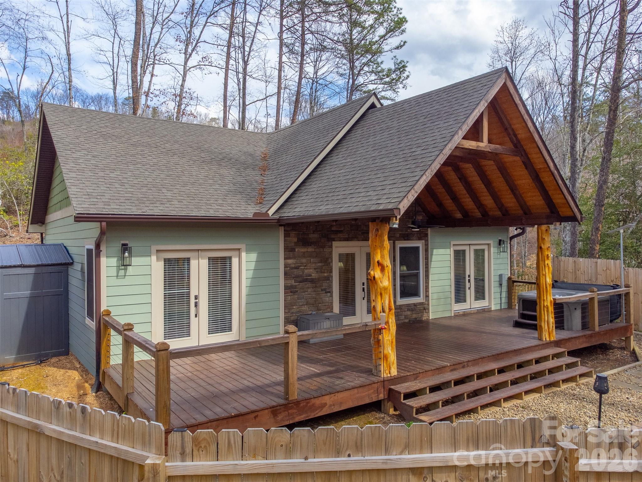 This stunning modern rustic home, like new and beautifully maintained, showcases charming log accents, soaring planked ceilings, and a spacious open concept floor plan with a desirable split bedroom layout. The well appointed kitchen features upgraded countertops, a stylish tile backsplash, and ample space for entertaining.  Ideally located between Bryson City, Cherokee, and Sylva, NC this home offers both convenience and mountain serenity. Each generously sized bedroom includes its own bathroom, providing comfort and privacy for family or guests.  Step outside to enjoy the oversized, partially covered front deck complete with a hot tub, perfect for relaxing under the stars and taking in the breathtaking views of the Blue Ridge Mountains.  Whether you're searching for a full time residence, a second home, or a high-demand vacation rental investment, this exceptional mountain property offers the best of Western North Carolina living.