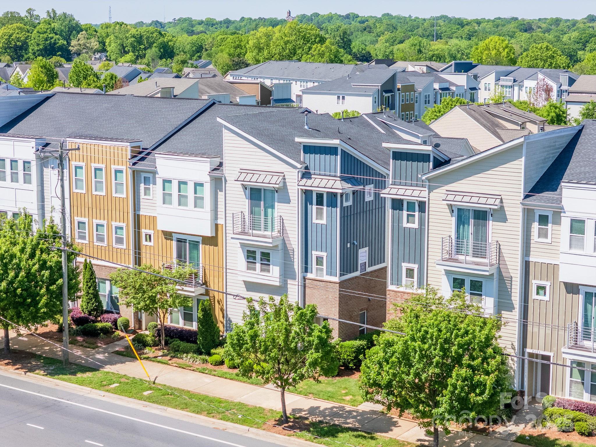 Amazing opportunity to live near one of Charlotte’s hottest spots—Camp North End! This 3-story end-unit townhouse in Brightwalk features 3 bedrooms, 3.5 bathrooms, and a 2-car rear-entry garage. The entry level offers a private bedroom with en suite bath, ideal for guests, a home office, or gym. The main floor showcases an open layout with recessed lighting, an entertainer's kitchen with stainless steel appliances, granite countertops, large island, and sleek backsplash. Accent wall and built-in electric fireplace add to the modern ambiance, and the living area opens to a cozy deck through sliding glass doors. Upstairs, the primary suite offers a walk-in closet, dual vanity, and glass-enclosed shower. A second bedroom includes its own bath and private balcony. Full laundry on this level adds convenience. A great rental investment, this home’s flexible layout and prime location near Uptown and Camp North End make it perfect for long- or short-term rental income. Can be sold furnished and property manager in place making it turnkey for an investor! Currently operating as a successful AirBnB with high occupancy rates.