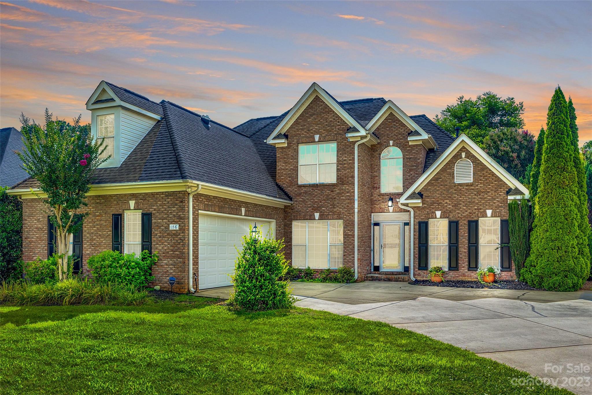 This stunning residence nestled in the serene Lake Club Commons neighborhood in Rock Hill is just a stone's throw away from Ebenezer Park and Lake Wylie.  The heart of this home is an open-concept living area, where natural light cascades through expansive windows, illuminating the hardwood floors and emphasizing the fine craftsmanship. 

The adjacent kitchen is adorned with stainless steel appliances, double ovens, gleaming granite countertops, and custom cabinetry. Retreat to the main level primary suite with its generous proportions, tray ceiling and soothing color palette. The en-suite bathroom is spa-like, featuring a luxurious soaking tub, glass-enclosed shower, and elegant dual vanities.

Two bedrooms upstairs provide ample space for family and guests. The upstairs flex space adds more room for an office or tv room. In addition this community offers lots of amenities including weekly lawn care of your front and back yard, a community pool, clubhouse and tennis courts!