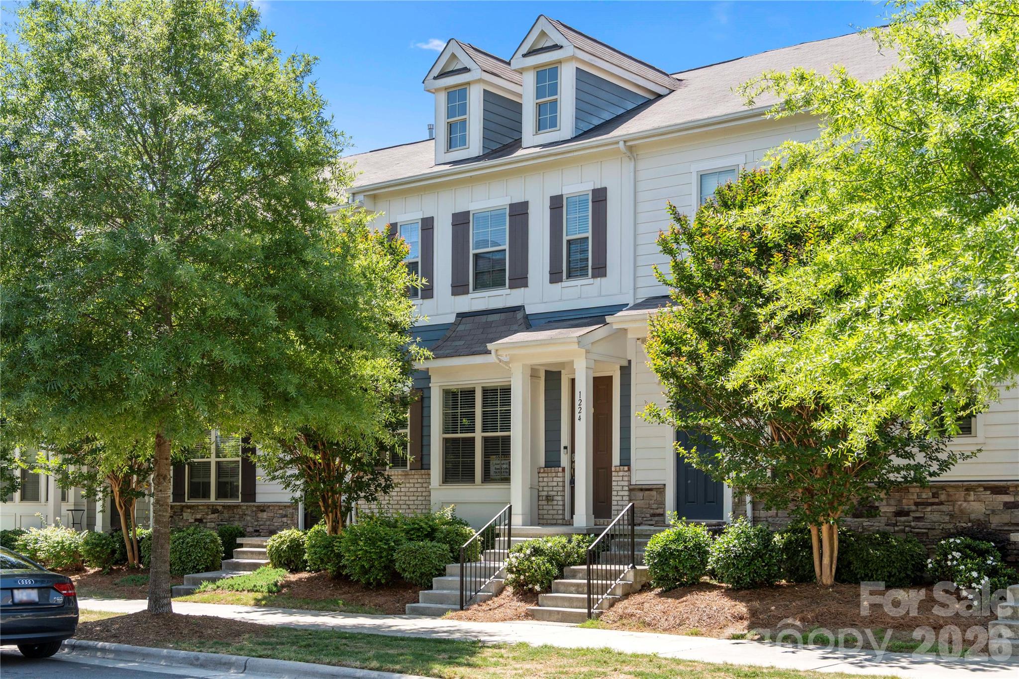 Located in the highly desirable Hadley at Arrowood community, this stunning three-story townhome offers the perfect balance of luxury and urban connectivity. Just steps from the Arrowood Lynx station, residents enjoy effortless light rail access for a seamless commute to South End, Uptown, and University. This prime location is complemented by upscale neighborhood amenities, including a private cabana and a sparkling outdoor pool, all just a short walk from your front door.

The home’s thoughtful layout is designed for both comfort and privacy. The upper level features dual primary suites, each equipped with spacious walk-in closets and elegant en-suite baths featuring granite countertops and custom tile work. The lower level provides a versatile third bedroom with its own full bath and direct access to the two-car garage—an ideal configuration for a home office, guest suite, or roommate living.

The heart of the home is the bright and airy main floor, where an open-concept design connects the kitchen, dining, and living areas. The gourmet kitchen, anchored by a large island, serves as the perfect hub for entertaining, while large windows flood the space with natural light. For outdoor relaxation, the main floor deck extends the living space, offering a quiet retreat. 

Professional photography will be available on May 5th; additionally, the sellers are open to providing a painting allowance with a competitive offer.