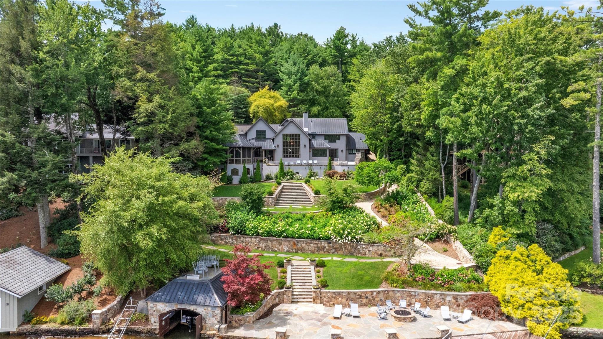 One of Lake Toxaway and Western North Carolina's finest homes, this acclaimed Keith Summerour designed residence is situated on a stunning lakefront lot very close to The Lake Toxaway Country Club, Greystone Inn, and Marina.  Featuring three bedroom suites and two half baths, this magnificent home has many luxury features including a copper roof, copper clad windows, copper gutters, impressive great room with soaring stone fireplace and massive window framing the water, chef's kitchen with Sub Zero and Wolf appliances, wine room, expansive stone terrace with fireplace, and beautiful octagonal screened porch with additional outdoor fireplace.  This estate level property also features a cart path to the lake, large stone dock with gas firepit, and one of the most attractive boat houses on the lake.