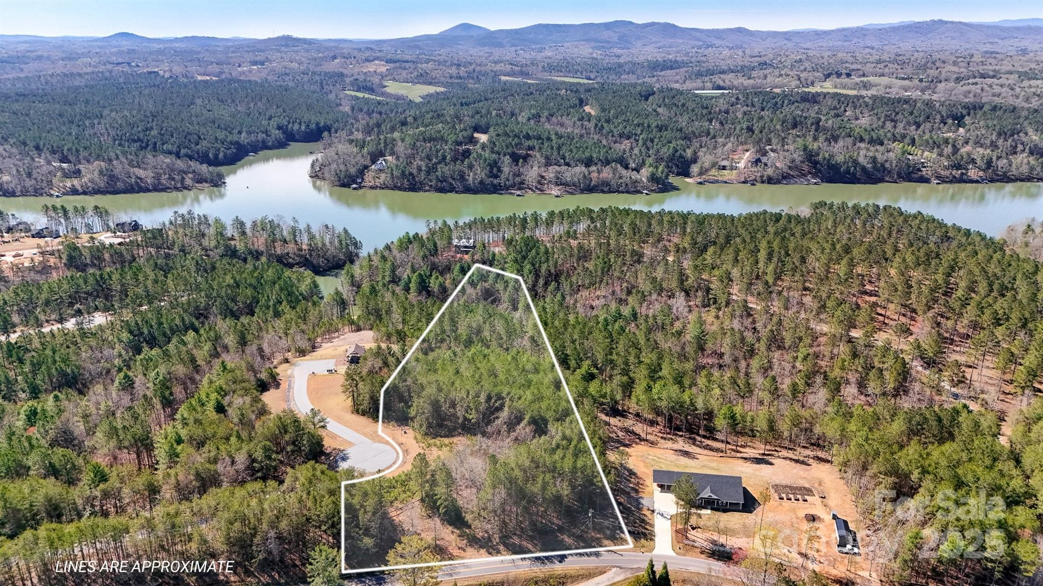 Discover the perfect blend of privacy, luxury, and natural beauty with this expansive 4+ acre lot in the gated community of Edgewater located at Lake Rhodhiss. This parcel offers a prime opportunity to build your dream home or weekend retreat. Enjoy the best of lakefront community living with the neighborhood common area located within walking distance of the property. The community features private amenities, including a covered pavilion, fire pit, and picnic area. Conveniently located near Hickory, Morganton, and Lenoir, this property provides easy access to shopping, dining, and entertainment while maintaining a peaceful, secluded feel.