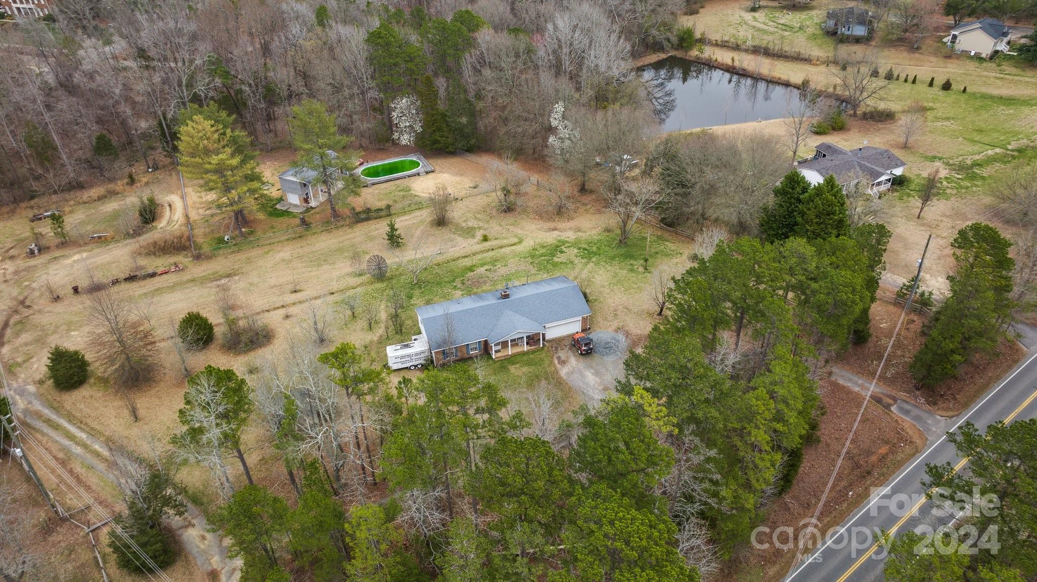 Located in a growing area, this large 5.04-acre property, which is zoned as Neighborhood Business, offers tons of possibilities! It could be used as a commercial property and offers a great opportunity for businesses, but it could also be rezoned as residential if someone wants to build houses on the property. The lot can also be subdivided if desired. Public water and sewer are available. The property currently has a 3 bed/2 bath home, as well as a heated and cooled two-story outbuilding with a half bathroom. Conveniently located near shopping, dining, and the NC state line. It also has access from Marvin Rd and road frontage on Ralph Hood Rd. Come see this property, today!