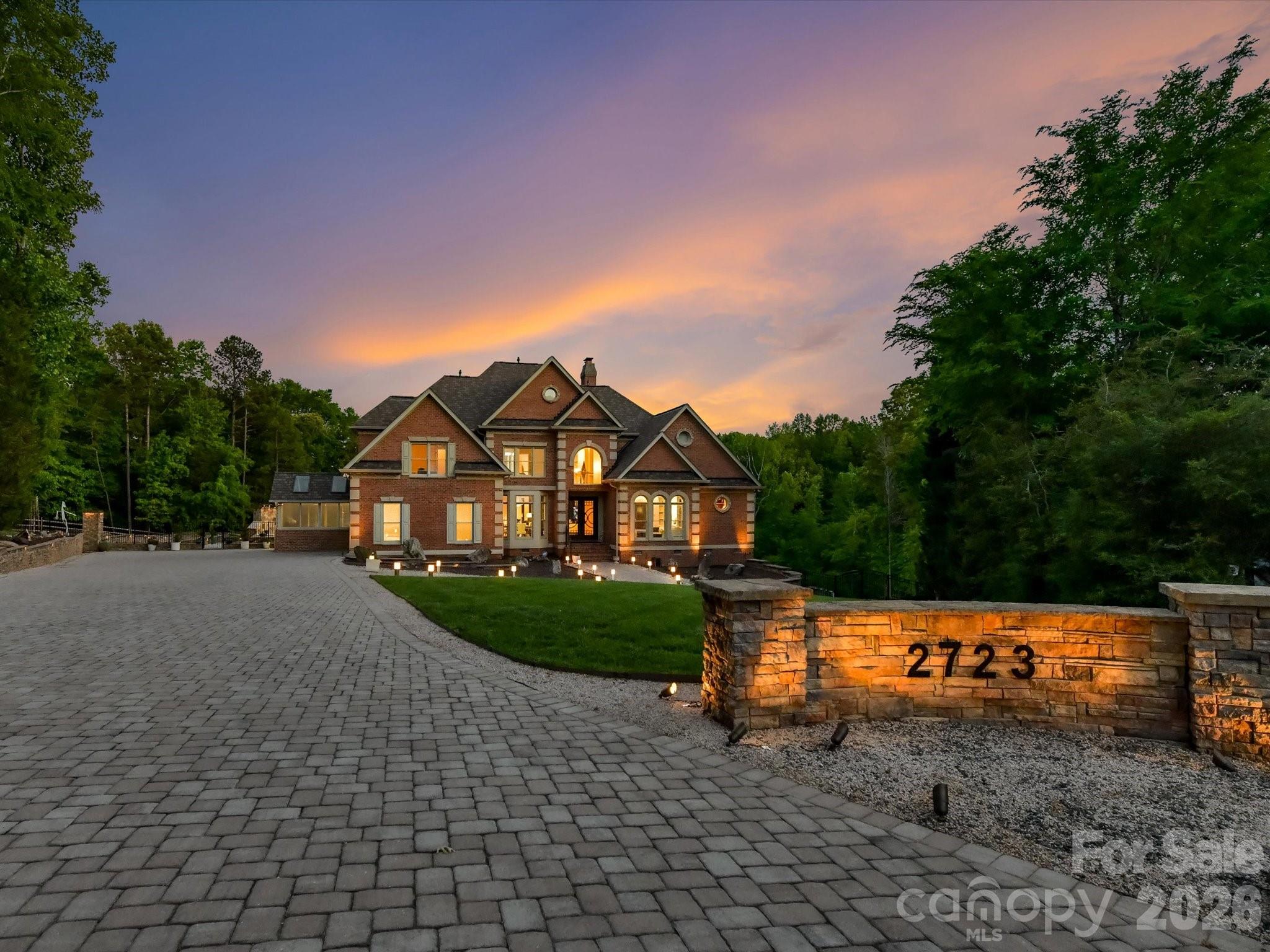 Set on 1.4 private acres in Charlotte’s sought-after Providence Plantation, 2723 Providence Pine
Lane is a masterfully redesigned estate where design, function, and resort-style living converge.
Thoughtfully transformed with over $2.5M in curated enhancements by Simonini and Alair, this
home offers exceptional scale, versatility, and seamless indoor-outdoor living. The main level
features an open yet intentional layout anchored by a chef’s kitchen designed to impress,
complete with a massive wraparound island with Magma Gold leathered granite countertops,
dual dishwashers and gas ranges, warming drawer, and a showstopping 18.5-foot refrigerator/freezer.
A 15-foot butler’s pantry with wine and beverage refrigeration leads to a rare, custom, four seasons
greenhouse-inspired sunroom, blending beauty and function. The primary suite is a private retreat with terrace
access, spa-like bath, and its own laundry, while custom steel beams and designer lighting
elevate the entire main floor renovation. The walk-out lower-level lives like a true second
residence, featuring a full kitchen, living area, fireplace, fifth bedroom, and private access, ideal
for multi-generational living or guests. The stunning solarium showcases heated travertine floors,
skylights, a linear fireplace, and 10-foot accordion-style glass doors that open to the backyard.
Outdoor living rivals a private resort, with over 6,000 square feet of travertine terraces, a custom
outdoor kitchen with pizza oven, fireplaces, a putting green, bocce court, and a spa, all
surrounded by architecturally designed landscaping. Upstairs, additional bedrooms, a flex space, walk-in and
walk-up attic access, a second laundry, and an expansive walk-in closet offer flexibility. With
new windows, systems, whole house generators, and top-to-bottom renovations throughout, this
is a rare opportunity to own a truly turnkey estate defined by craftsmanship, intentional design,
and exceptional livability.