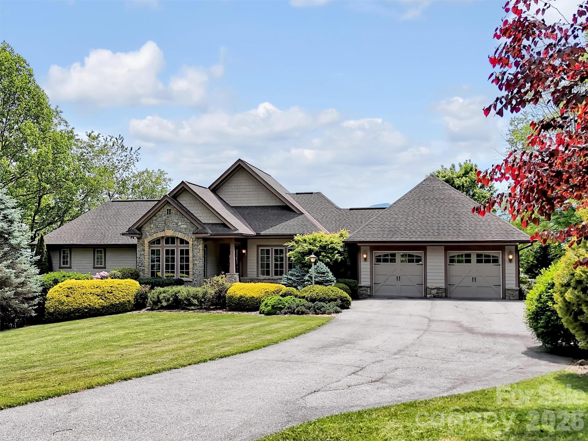 Experience refined mountain living in this gorgeous custom-built home located in the desirable Laurel Ridge Country Club. This home offers captivating long-range mountain views & golf course views with convenient year-round access, just minutes from downtown Waynesville or a golf cart ride to the clubhouse. Designed for both comfort & entertaining, the spacious great room features soaring ceilings, breathtaking mountain views & abundant natural light. Great Room has crown molding, gas fireplace, beautiful built-ins, & flows seamlessly into an inviting covered outdoor living space complete with a wood burning fireplace, overlooking the views! The well-appointed kitchen is a chef’s dream, featuring a gas range, ample cabinetry, walk-in pantry, & a charming & bright eat-in breakfast area, perfect for casual dining. A wet bar conveniently connects the kitchen & dining room, creating an ideal flow for entertaining. The thoughtfully designed floorplan includes 3 private ensuite bedrooms, including a luxurious primary suite on the main level.  Main level also has a cozy office/den & an oversized laundry room with a butler's pantry functionality. The lower level offers a spacious family room that opens to a private patio, creating additional space for relaxing or entertaining guests, along with generous storage. Exceptional craftsmanship & timeless details are found throughout this stunning home, which also includes a generator for peace of mind & comfort year-round.