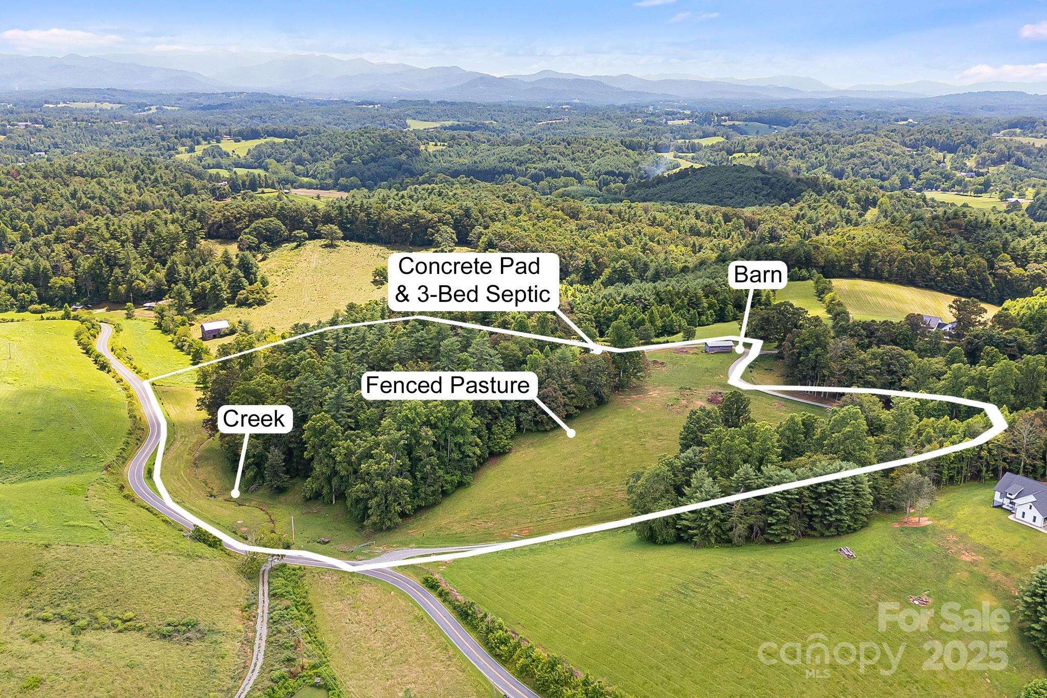 Located in Buncombe County with amenities just a few minutes away, this is a dream property if seeking land with views, fenced pasture, & a great building site with well & septic already installed. As a bonus, there is already a build-ready 36x50 concrete slab with stubbed out plumbing ready for your outbuilding, workshop, garage, or whatever else you may need it for. This property will make a great private estate, mini-farm, or great mountain vacation home. Seller to subdivide approximately 12.15 acres off of larger parcel prior to closing. There is already fenced pasture, partially wooded, with a babbling creek that runs parallel to the road and approximately 856' of road frontage. There is abundant wildlife on the property as well - turkey and deer are daily visitors. This is a must see property for those seeking privacy and tranquility in the country. Shown by appointment only. Video here: https://listings.wncrealestatephotography.com/videos/01982d55-6611-70ef-ac25-9a78822e5785