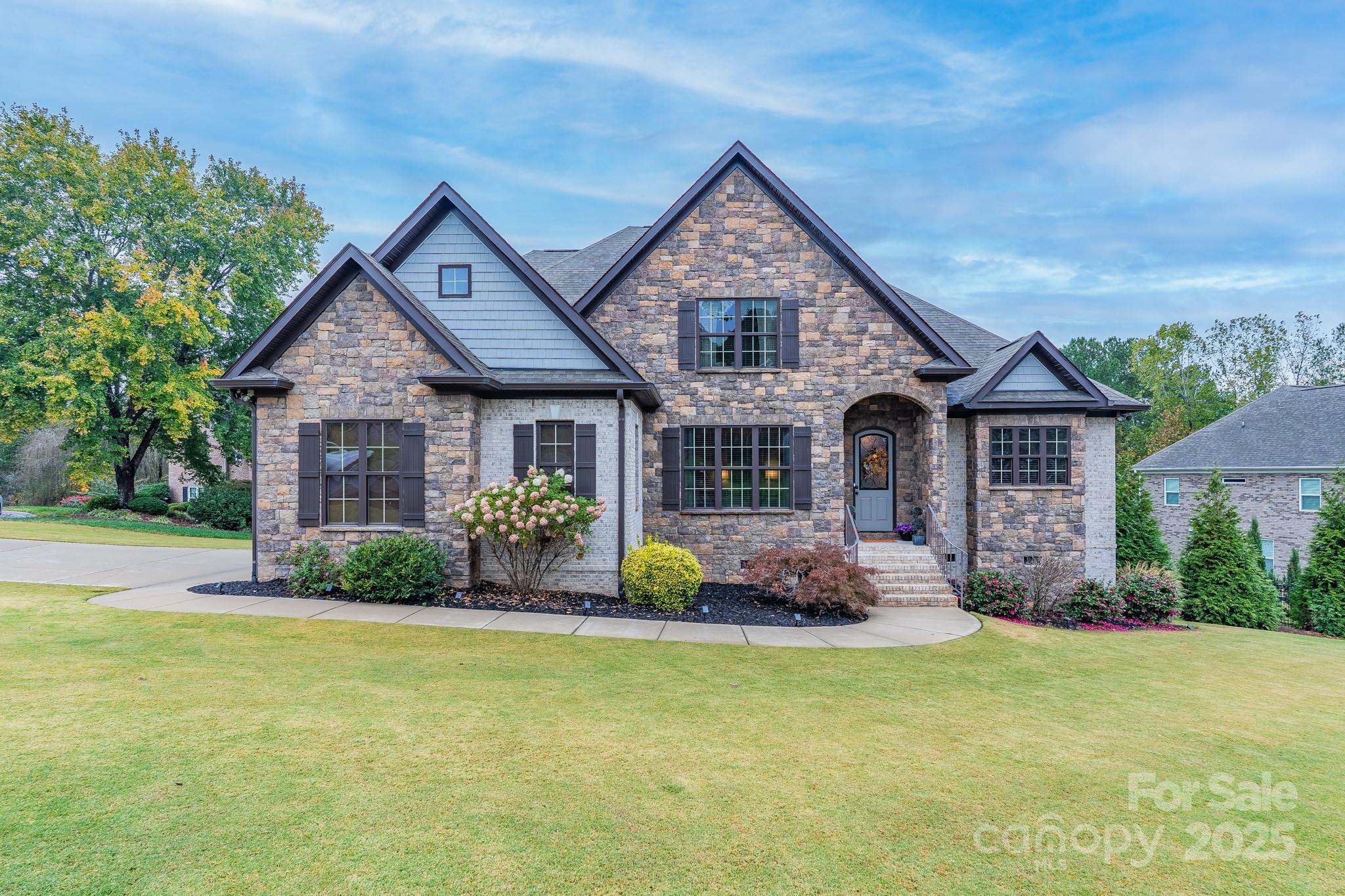 This showstopper is sure to impress you from the moment you step on the property!  From the front entrance to the backyard oasis, this one is filled with upgrades.  The main level features beautiful bamboo flooring, bringing consistency and warmth throughout.  A two-story family room with fireplace is the perfect entertaining spot, especially with the openness to the kitchen.  The chef will enjoy the time spent preparing meals with gas cooktop, wall oven, stainless appliances, granite, spacious island with seating, and breakfast area.  The separate dining room will serve you well for both formal and informal meals.  The main level primary suite features a large bedroom and recently upgraded private bath.   Featuring separate vanities, a gorgeous soaking tub, new tile shower, and wood accents, the primary bath will captivate your time as you will never want to leave this private spa-like setting.  A second bedroom and full bath are on the main level as well.  Upstairs is home to three additional bedrooms, a bonus room, and full bath.  Enjoy your mornings on the screened porch overlooking the highlight of the backyard – your private “resort living” with gorgeous gunite saltwater pool, hot tub, stone fireplace, and firepit!  You will be the envy of the neighborhood and outdoor entertaining will leave your guests speechless.  An attached double garage will serve you well, especially on those cold or rainy mornings!  All of this – and located on a cul-de-sac along the 18th fairway at Waterford Golf Club.  Make your appointment today to check out 703 Waterford Glen Way, then head out to start packing!
