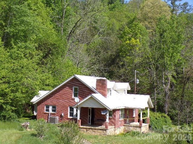 For buyers seeking a full-scale project, this property offers the opportunity to create an entirely new vision in a classic mountain setting. The traditional 1.5-story farmhouse sits on approximately 100 acres in rural Spring Creek Valley, featuring open pastureland, wooded hillsides, creek frontage, and long-range mountain views. The outbuildings include a multi-car tandem garage/workshop, an equipment building, and a livestock barn.

The property is located in the scenic Spring Creek Valley, surrounded by steep hillsides and a stream that ultimately flows into the French Broad River. Just down the road is the Spring Creek Community Center, a long-standing gathering point for local residents. The broader Hot Springs area is well known for Appalachian hiking, fishing, and outdoor recreation.

The home and all outbuildings require restoration. This is an estate transaction, and the sellers have never occupied the home. Recorded rights-of-way exist for adjoining property owners. Due to the property's overall condition, it will not meet all financing requirements.

All inspections are for buyer information only; the sellers will not perform or pay for any repairs, including those required by an appraisal. The property is being sold strictly “As Is,” “Where Is,” and “With All Faults.” The seller is a trust representing the estate of the owners who passed away and therefore makes no warranties or representations, express or implied, including any warranties of merchantability or fitness.

No well permit was located. Because the county’s recorded construction year conflicts with the home’s observed materials, the true age of the dwelling is considered unknown. It is also unknown whether any buried fuel tanks exist on the property.

A portion of the acreage across Hwy 209, as well as approximately one-third of the 25-acre pasture used for hay, is located within the designated floodway zone.

Property showings are available by appointment only. Please contact your Realtor to schedule a time.