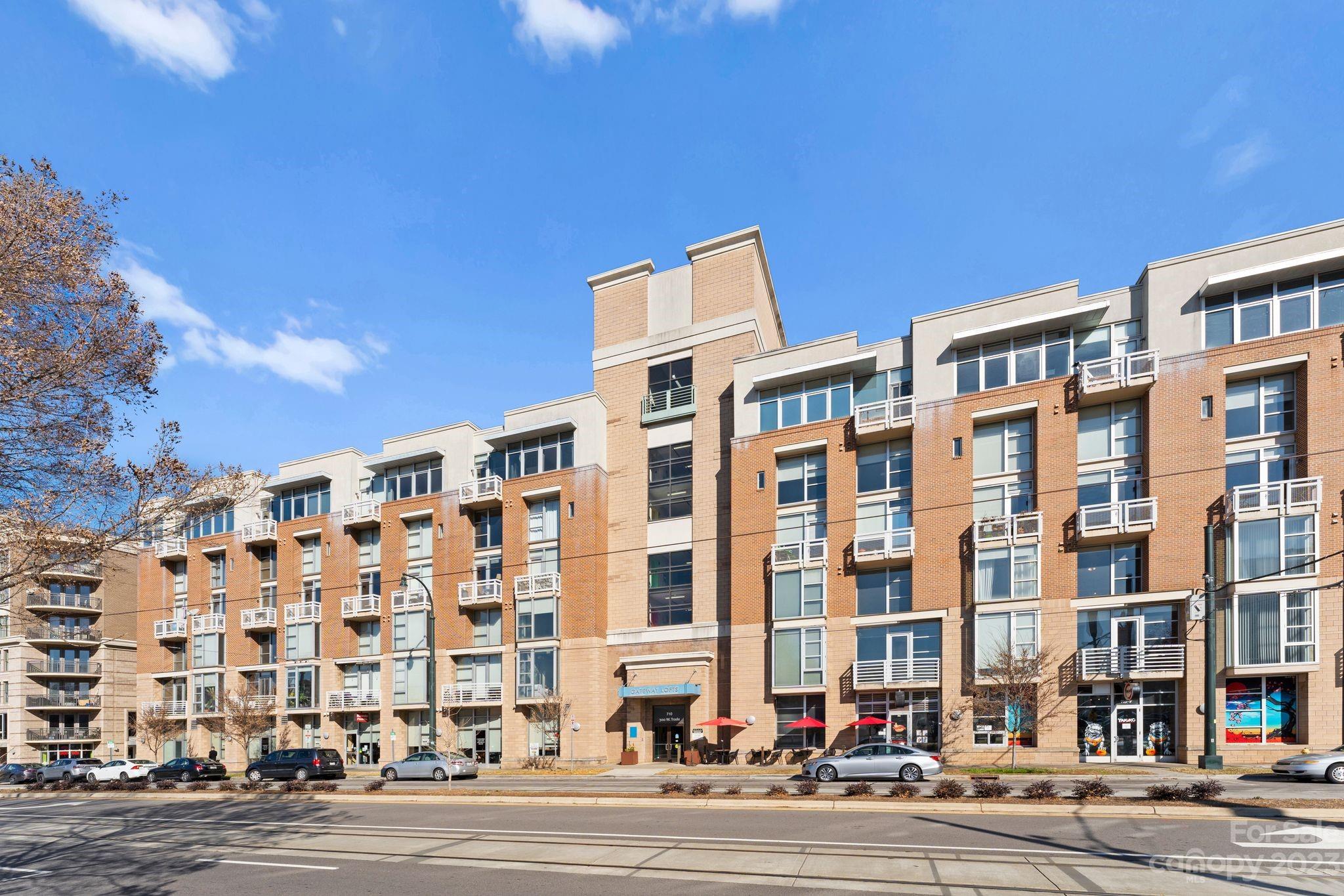 This top-floor condo at Gateway Lofts in Uptown is the epitome of urban sophistication. Space meets style in this condo, which offers a unique blend of industrial charm and contemporary living. The expansive 13’ ceilings and exposed brick walls evoke a sense of grandeur. The open-plan living area is framed with a stunning Uptown skyline view, welcoming natural light that dances across the space. Retreat to your serene bedroom featuring a walk-in closet that promises ample space. Sophistication extends to the bathroom, where you can revel in the tiled walk-in shower. Enjoy the multi-functional flex space which could easily be used as an at-home office. Convenience is abundant with parking on the same floor as the unit. Just outside your front door, Charlotte's city life pulses with excitement with two Lynx Gold Line stops, Truist Field and Bank of America Stadium just a short distance away. This isn't just a condo; it's a ticket to Uptown Charlotte living at its finest.