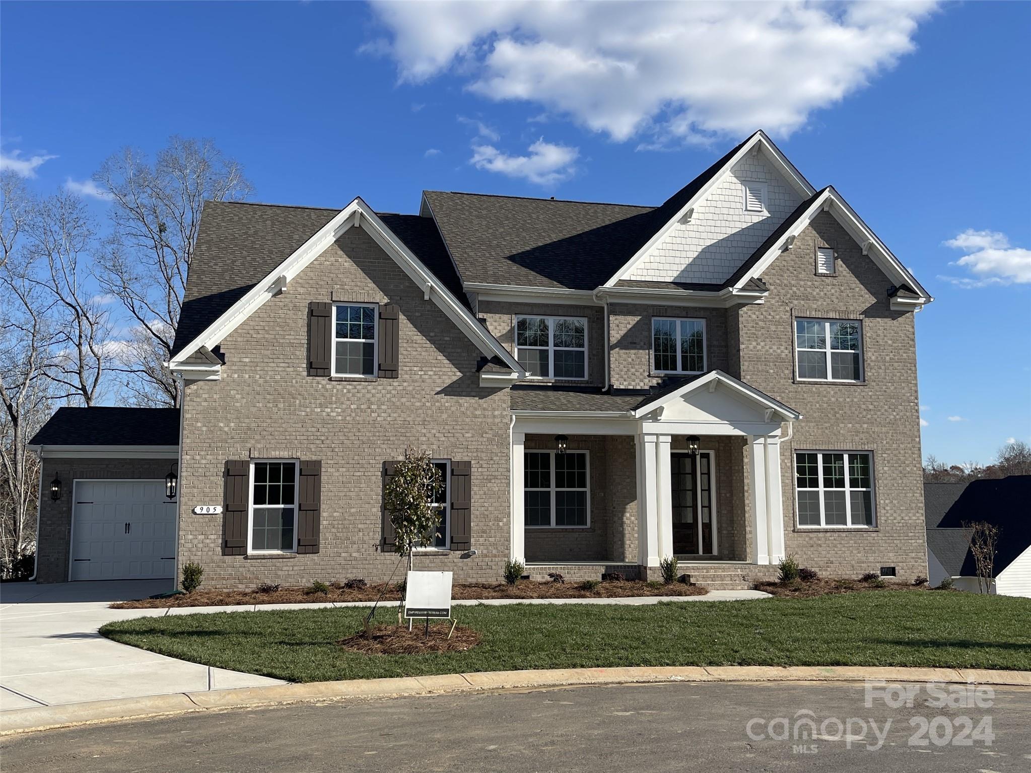 4-sides brick home on a .51 acre cul-de-sac homesite that backs up to mature trees. Extra storage space in the tall crawl space! 1st floor guest suite, rear covered porch, Living rm w/ French doors, Bonus Rm & 3-car garage. Butler's Pantry w/ cabs & wine fridge connects the Dining rm w/ Kitchen. Mudroom drop-zone. Family rm w/ gas FP & 16' sliding doors to the rear porch. Kitchen has quartz counters & backsplash, LED UC lights, trash pullout, soft close doors/drawers, large walk-in pantry, GE Profile SS app w/ 36" gas cooktop & extraction hood vented outside. 5 beds most w/ their own full bath & 2 rooms share Jack-n-Jill bath + bonus Room. Primary Suite w/ huge walk-in closet & tray ceiling. Bathroom w/ free-standing tub, large tiled shower w/ frameless surround, & quartz counters. 6.5" French oak hardwoods. Community resort-style amenities & Ft Mill schools.