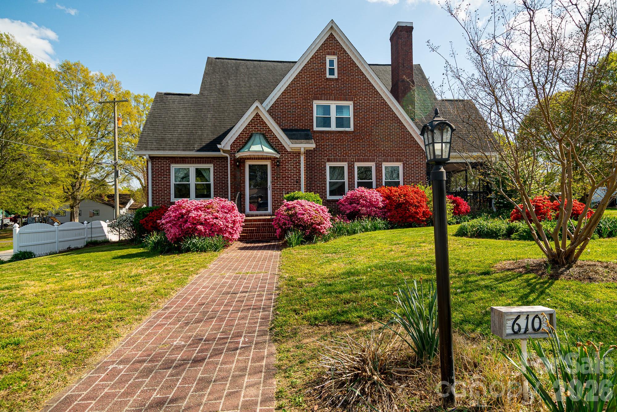 MAGNIFICENT 3600 SF Historical Cornwell Home in Blossoming Downtown Cherryville on half an acre!  Walk to Quaint Shops and Restaurants, Library across the street and Elementary School 1/2 block away! This Spacious Home has a blend of Old and New Features... Gorgeous Original Hardwoods and Updated New Quartz Countertops/Tumbled Marble Floors in Kitchen. You will really enjoy the Sunny "Canning Kitchen"... Large Multi-Purpose room for Laundry with plenty of Cabinets and Counterspace!  Sun Porch AND Screened Porch! Fenced in Yard with a Raised Bed Garden!  2000 SF FIVE BAY GARAGE is another feature that makes this property an incredible value!! 2 bays are a heated/cooled workshop. Don't miss the FULLY ENCAPSULATED BASEMENT! SO MUCH STORAGE!! The new insulation that was added make the heating and cooling bills of this home quite affordable. All utilities are paid to City of Cherryville...electric, water/sewer, trash and average only $250/mo!!