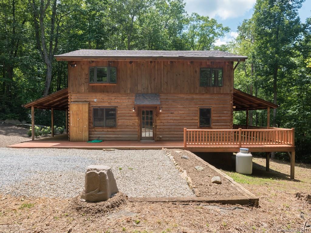 True mountain style living in Fairview! Come see this adorable log home surrounded by an acre of rhododendron and native plants. Great private location only 15 miles from downtown. SS appliances(brand new dishwasher) & granite countertops. The whole house has been freshly painted & brand new carpet upstairs. Enjoy the open floor plan & cozy stone fireplace. Relax on the wrap-around covered porch and listen to the creek as your worries melt away. Adjacent lot for sale (3273231)shares driveway