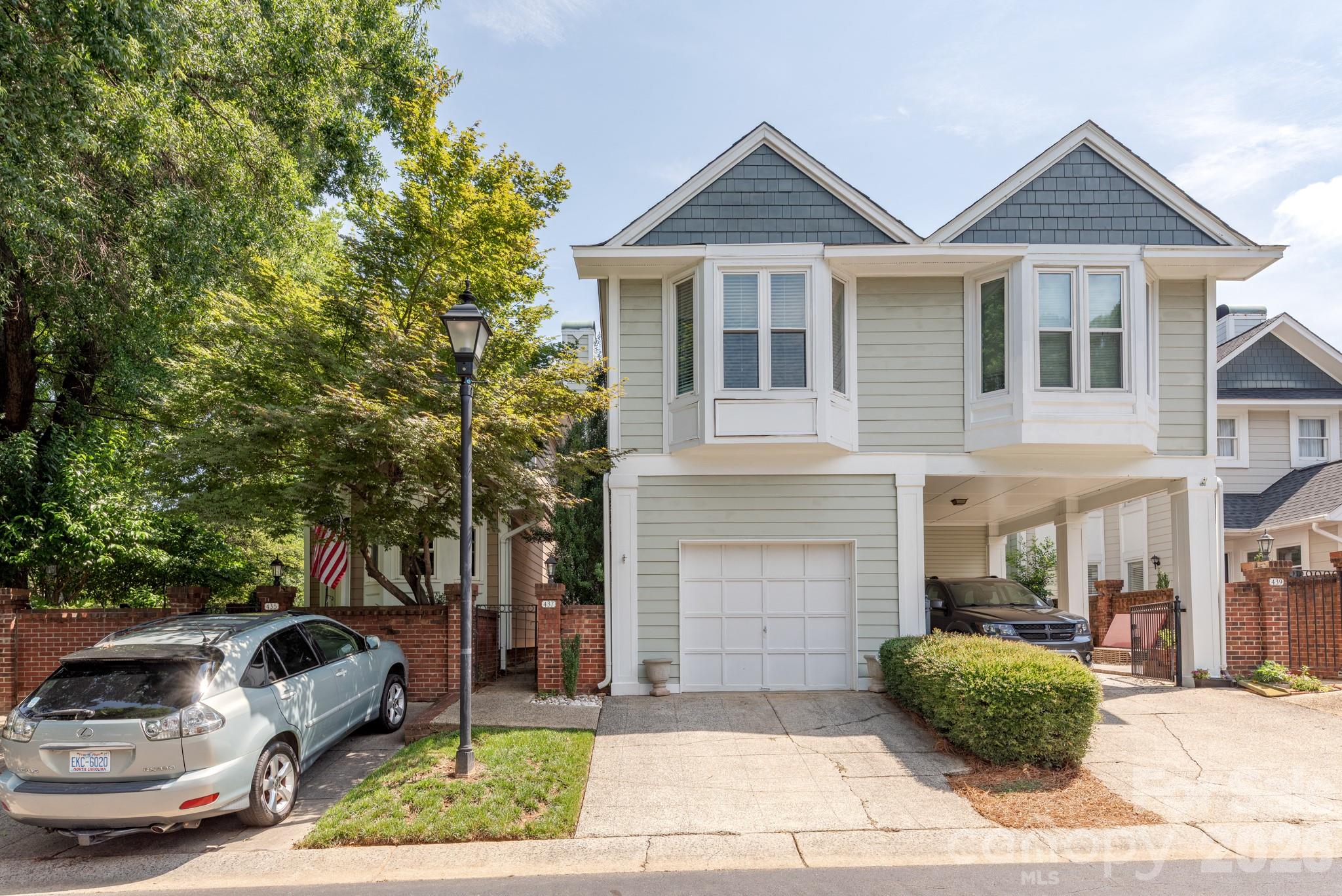 Welcome to 437 Clarkson Green St, where the excitement of Uptown Charlotte meets the privacy and charm of one of Third Ward's most sought-after townhome communities. Just moments from Bank of America Stadium, Truist Field, Romare Bearden Park, and countless restaurants and entertainment options, this beautifully updated residence offers an exceptional lock-and-leave lifestyle in the heart of the city. Inside, you'll find an inviting open floor plan filled with natural light, warm hardwood floors, and thoughtfully updated finishes throughout. The renovated kitchen features quartz countertops, stainless steel appliances, abundant cabinetry, and a breakfast bar that seamlessly connects to the dining and living spaces—perfect for everyday living or entertaining guests. French doors open to a private, fenced patio, creating the ideal outdoor retreat for morning coffee, evening cocktails, or dining al fresco. Upstairs, three spacious bedrooms provide comfortable accommodations, including a primary suite and a guest bedroom with stadium views that remind you just how close you are to Charlotte's premier sporting events and concerts. A rare attached one-car garage, additional driveway parking, and low-maintenance living make this home an outstanding opportunity for homeowners seeking convenience without sacrificing comfort. Whether you're walking to a Panthers game, catching a baseball game, exploring nearby parks, or enjoying Uptown's vibrant dining scene, this home places the very best of Charlotte right outside your door. Experience the perfect blend of urban convenience, modern updates, and neighborhood tranquility at 437 Clarkson Green Street.