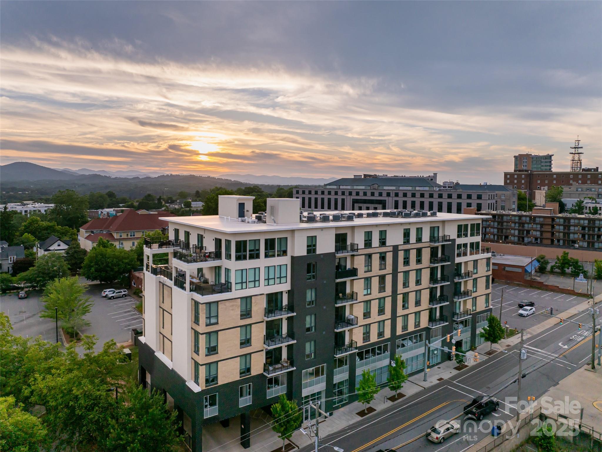Investor Opportunity! Chic Downtown Asheville Condo with STR Permit. Welcome to Unit 405 at 45 Asheland, a rare opportunity to own a beautifully appointed 2-bedroom, 2-bath condominium in the heart of downtown Asheville, complete with a short-term rental permit that conveys with the sale. Bathed in natural light, this east-facing residence offers lovely views of the city and distant Blue Ridge Mountains. Refined finishes throughout the home reflect the signature elegance of 45 Asheland, including Bosch appliances, quartz countertops, and Kohler fixtures. Whether you’re seeking a private urban retreat or a savvy investment property, this stylish condo delivers. Enjoy the vibrant culture of downtown Asheville just steps from your door & when you're away, share your haven with guests through short-term rentals. Additional features include a deeded, secure parking space & a climate-controlled storage unit conveniently located on the same floor as the residence. Live well. Invest wisely.