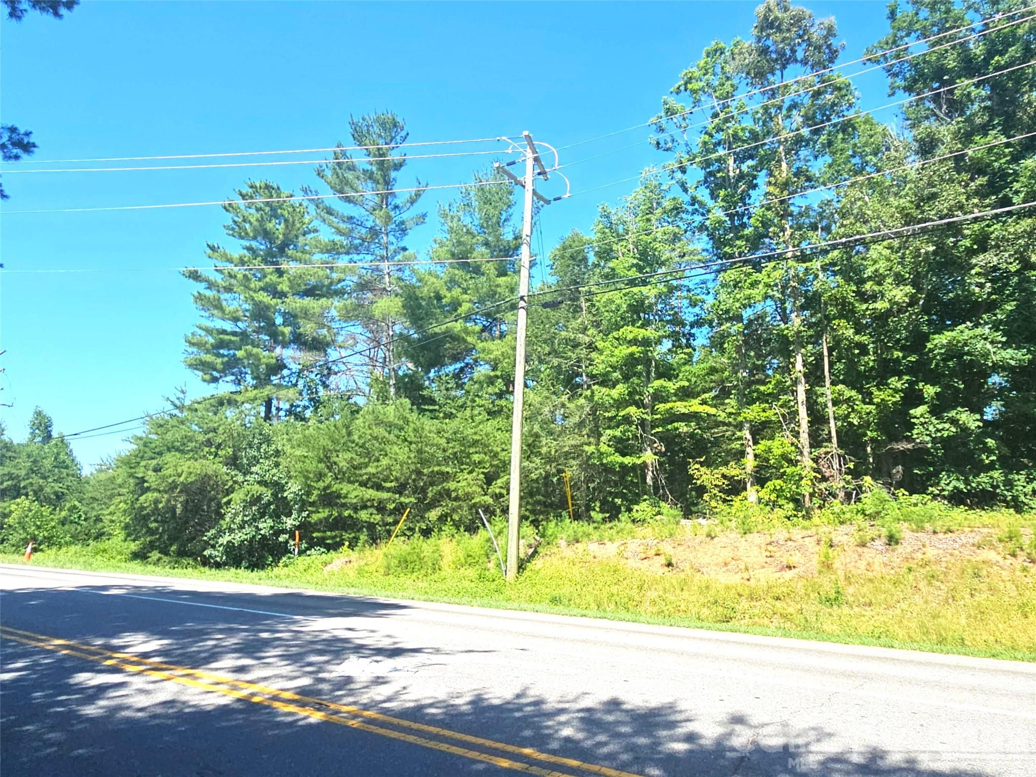 Exceptional 13.26-acre wooded tract ideally positioned for residential or mixed-use development in one of the area's fastest-growing corridors. Located just blocks from Northcrest Shopping Center, featuring Walmart, Lowe's, and other major retailers, this property offers outstanding visibility and accessibility near the intersection of US 25/70 North and I-26. The site is strategically situated near the proposed Advent Hospital and is surrounded by expanding retail, multifamily, and commercial development. Bordered by established multifamily communities on both sides, the property is well suited for future residential development. Public utilities are available nearby, enhancing development potential. Enjoy convenient access to the amenities and services of Weaverville, with quick connectivity to I-26 providing an easy commute to Asheville's major employment centers, healthcare facilities, shopping, and entertainment. Contact the listing broker for additional information, development details, and ownership structure.