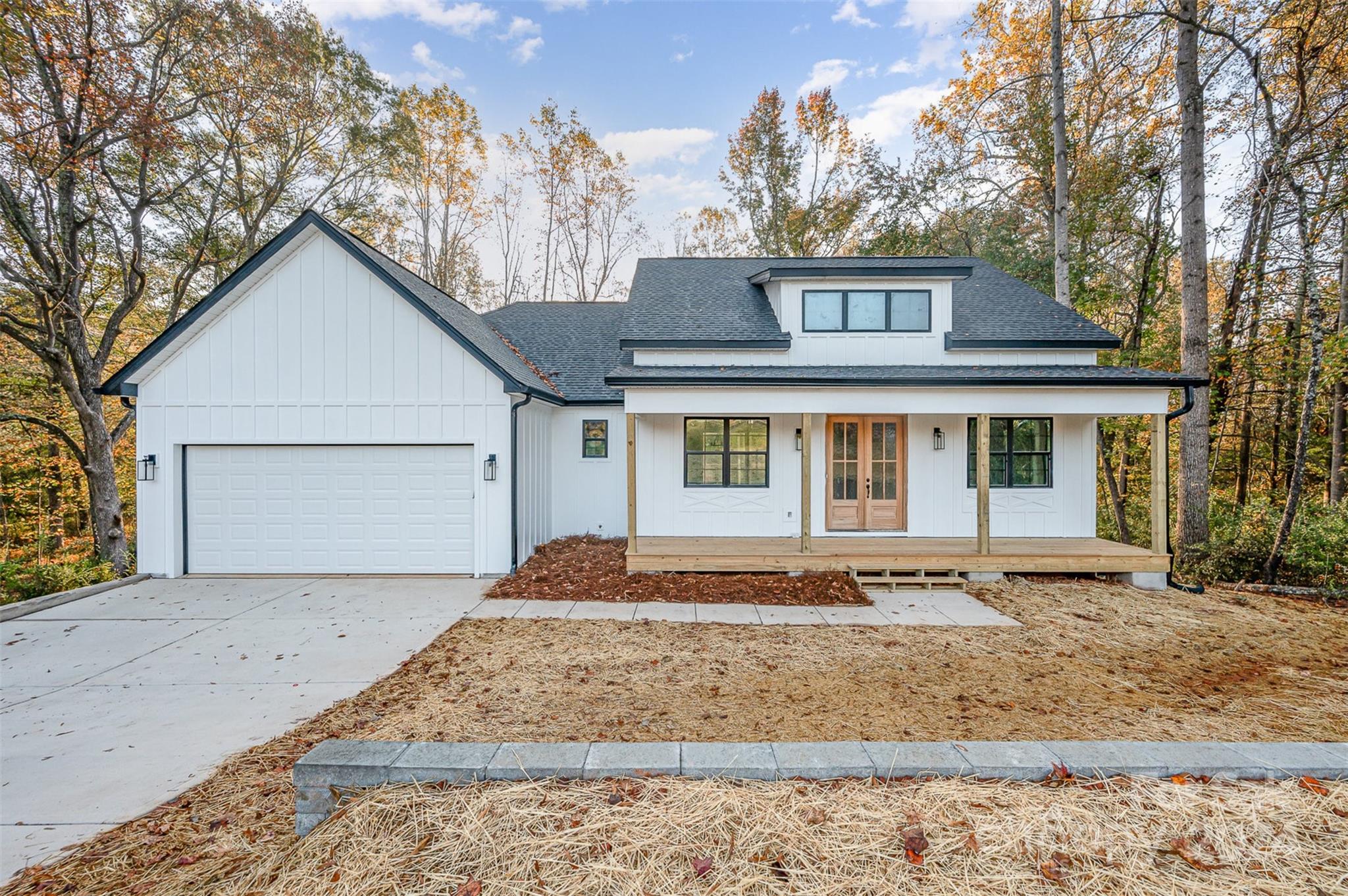 Welcome Home! This stunning new construction home features 4 bedrooms and 3.5 bathrooms, offering ample space for relaxation and entertainment. The main floor boasts an open layout with 3 bedrooms, including the primary suite, and 2 full baths, along with a spacious kitchen, inviting living room, and elegant dining area. Step downstairs to discover a massive family room with 12-foot ceilings—perfect for gatherings or movie nights. You'll also find an additional bedroom, a full bath, a massive walk out sliding door and plenty of unfinished flex space to complete however you like! Nestled among trees, this property offers unmatched privacy while being just a short stroll from downtown Clover. Enjoy the perks of county taxes without sacrificing proximity to the city. Backyard was designed for pool. Builder also installs pools and can discuss custom options if interested. Basement half bath has exterior access for future pool guests. Don’t miss your chance to make this home yours!