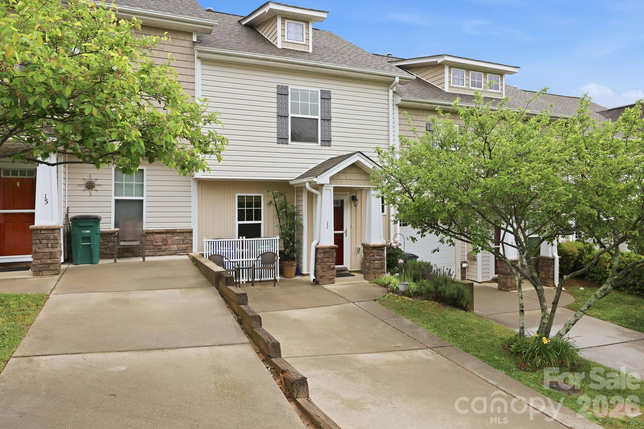 Discover the perfect blend of modern convenience and welcoming mountain living in this delightful 2-bedroom, 2.5-bathroom townhome, ideally situated within the highly sought-after Creekside Village community in Weaverville. Interior Features and Layout | Step inside to a light-filled and bright open floor plan on the main level, designed for seamless living and entertaining. The main level features a well-appointed living space that flows into the dining area and kitchen, offering a good combination of a modern feel while retaining a warm coziness throughout. A convenient half-bath is also located on this level. Upstairs, you will find two generously sized bedrooms, one with its own full, private bathroom and walk-in closet. This smart layout ensures comfort and privacy. The upper level also houses the dedicated laundry area, making chores easy and efficient. Outdoor Living and Location Highlights - Embrace the peaceful mountain atmosphere with two distinct outdoor spaces. The private back patio is perfect for relaxing, enjoying a morning coffee, or unwinding in the evening while taking in the serene mountain views. The covered front porch/patio space provides a welcoming spot to visit and connect with friendly neighbors, fostering a true sense of community. The location is second to none, offering the best of Weaverville living. You are just minutes away from the charm, shops, and restaurants of Historic downtown Weaverville. Additionally, the beautiful Lake Louise Park is only a short, pleasant stroll away, providing easy access to walking trails, fishing, and recreational activities. This townhome offers not just a residence, but a lifestyle, combining an excellent location with comfortable, well-designed living spaces.