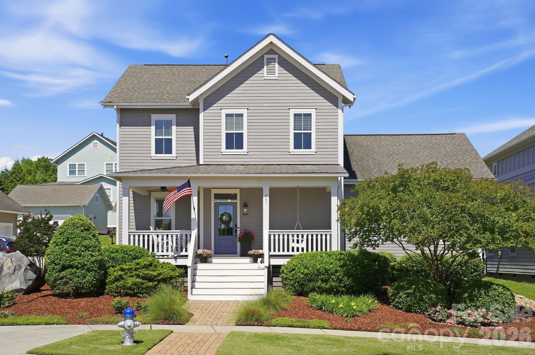 Experience the ultimate RIVERWALK lifestyle in this METICULOUSLY MAINTAINED, craftsman-style Evans Coghill charming home! Nestled on a prime CORNER LOT directly across from serene open green-space, this MOVE-IN READY gem blends southern charm with sophisticated modern updates. From the moment you arrive, the timeless architecture and beautifully-manicured landscaping impress with inviting curb appeal. Boasting 4 bedrooms and 2.5 bathrooms across 2684 square feet, every inch of this home has been thoughtfully designed for modern living. Soaring 9' ceilings and heavy crown moldings throughout home. The stunning Kitchen is a true chef’s delight featuring upgraded 42" white cabinets with glass, stainless steel appliances, gas range, granite countertops, an expansive central island, tiled backsplash, and a walk-in pantry. The heart of the home flows from the kitchen through the dining area into the  living space with cozy gas fireplace - all ideally made for everyday moments and easy entertaining. Enjoy views to the FENCED BACKYARD from the generous-sized living room. Your private sanctuary awaits on the spacious MAIN-LEVEL PRIMARY SUITE with tray ceiling, dual vanities, a large walk-in shower, and walk-in closet. A beautiful, custom-made drop zone adds beauty and function as you enter the primary oasis. Flexible Living includes a dedicated home office on main level and a versatile second-level loft perfect for a media center or playroom. Three bedrooms and full bath complete the second-level. Loaded with RECENT UPGRADES including exterior & interior paint, refinished (light-colored stain) site-laid hardwood floors, hardwood finished staircase, newer carpet on second-level, irrigation in front and back of home, fenced back yard, drywall & epoxy floor in garage and plantation shutters throughout home. Step outside to your private retreat. The covered back porch is perfect for morning coffee or evening entertaining, overlooking the perfectly-manicured backyard. Additional paver patio space with exterior outlet wired for outdoor TV. The detached 2-car garage encloses the space for a true courtyard setting. Unmatched Riverwalk amenities include a community pool with lazy river, clubhouse, playground, sidewalks, scenic walking trails, canoe & kayak launch points, BMX Supercross Track, velodrome, criterium course, local dining, wine bar, shops, and convenient canoe/kayak access. This golf cart-friendly neighborhood offers quick access to I-77 (via the new Palmetto Parkway), Rock Hill, Fort Mill, and Charlotte—making it perfect for commuters and those seeking an active lifestyle. Experience the best of Riverwalk living in this home that shows like a model!