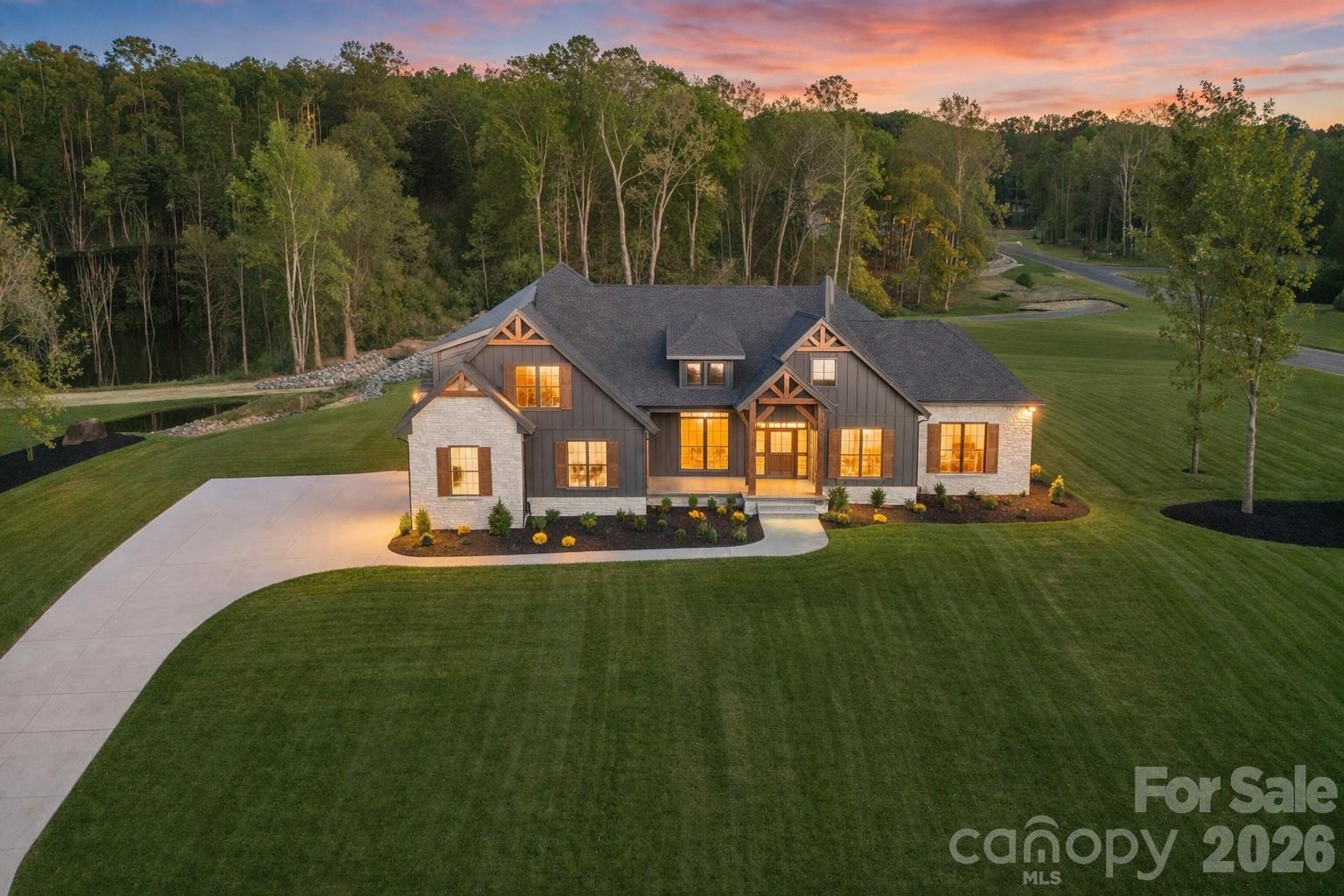 Welcome to a stunning custom residence in the highly sought-after Southern Pine Lake community, where timeless architecture, exceptional craftsmanship, and expansive homesites define a truly elevated lifestyle.

Perfectly positioned on a premium corner lot, this home immediately impresses with its striking exterior—featuring beautiful stonework, rich textures, and refined architectural details that set it apart from anything else in the Clover market. Surrounded by over an acre of land, the setting offers both presence and privacy, creating a true estate feel.

Inside, the home opens to a thoughtfully designed floorplan that blends sophistication with everyday livability. The open-concept layout is filled with natural light and anchored by a spacious great room with soaring ceilings, a designer fireplace, and custom built-ins—creating an inviting yet elevated space for gathering.

The chef’s kitchen is a true centerpiece, showcasing custom cabinetry, premium appliances, a statement vent hood, marble countertops, and an oversized island designed for entertaining. Every finish has been carefully selected, delivering a level of quality and detail rarely seen.

Designed for convenience and comfort, the main level features multiple bedrooms, including a luxurious primary suite that offers a private retreat. The spa-inspired bath includes a freestanding soaking tub, an expansive walk-in shower, and elegant finishes that mirror the home’s overall attention to detail.

Upstairs, additional living space provides flexibility for a bonus room, media space, or home office—perfect for adapting to any lifestyle.

Step outside to enjoy a covered rear patio overlooking the natural surroundings, offering a peaceful extension of the home ideal for relaxing or entertaining.

Located within Southern Pine Lake—an exclusive 36-homesite community known for its large lots and custom homes—this property offers a rare opportunity to own a home where quality, design, and setting come together seamlessly. All just minutes from dining, shopping, and a short drive to Charlotte.

This is luxury living, redefined.