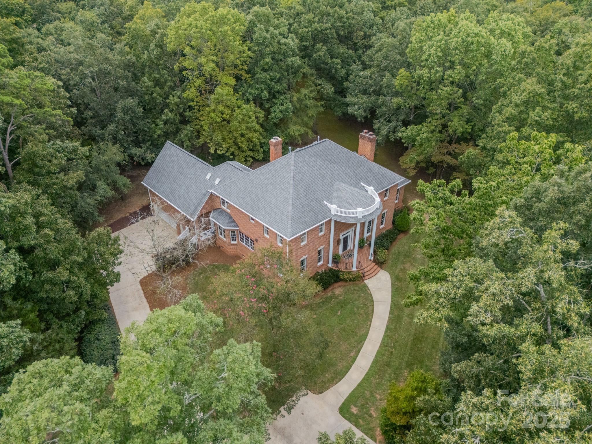 Timeless Southern Elegance Meets Modern Luxury in this One-of-a-Kind Georgian Estate 

Featured on the pages of Southpark Magazine for design, framed by the stately symmetry of classic Georgian architecture, this exceptional five-bedroom, seven-bathroom home is the very essence of Southern sophistication. From the moment you arrive onto the 2.72-acre estate, you're greeted by a sense of charm and hospitality that is unmatched. 

Step into the grand two-story foyer where floor-to-ceiling wainscoting panels set a tone of quiet luxury. Designer lighting illuminates the stunning craftsmanship and curated design details that unfold throughout. 

Designed for both gracious entertaining and everyday ease, the home offers a thoughtfully flowing floor plan, complete with a formal living room that has been professionally lacquered, with gas fireplace, an intimate family room with custom built-ins and wood-burning fireplace, a bourbon/wine room that has been insulated for temperature control, and a formal dining room — dressed in custom draperies made from original artwork by Charlotte’s Windy O’Connor and a one of a kind chandelier handcrafted by Raleigh artist Louise Gaskill, adding the perfect finishing touch for entertaining. 

The heart of the home is its show-stopping kitchen — featuring white marble countertops, a royal blue La Cornue CornuFe110 range with brass and stainless accents standing as a stunning centerpiece, flanked by Sub-Zero and Miele appliances seamlessly paneled to blend into Knot Yet custom cabinetry. Custom fretwork echoes throughout, from transoms and kitchen details to custom woodwork that lends both texture and tradition. A hidden walk-in pantry and Kohler pot filler enhance everyday luxury, while a Visual Comfort Paris Flea Market chandelier brings vintage flair to the breakfast area. 

Downstairs also features the oversized primary suite with yet another gas-burning fireplace, en-suite owner's bathroom, and custom walk-in closet. 

Upstairs, this remarkable home offers 4 secondary bedrooms all with en-suite bathrooms, thoughtfully designed with marble-topped Worlds Away vanities, classic tile, Delta Vero faucets, and Kohler cast iron tubs, a large bonus space, an additional office or family room for even more living space, and a convenient walk-up attic to provide additional storage. Two additional powder rooms downstairs each offer their own moments of design brilliance: one with a Scalamandré zebra-print wallpaper and a striking Greek key vanity; the other with Phillip Jeffries Imperial Gates grasscloth, a soft blue high-gloss trim, and an antique console-turned-vanity. 

Outside, you’ll find a serene screened porch perfect for slow Southern mornings or twilight gatherings, along with almost three acres of both wooded property and usable yard spaces. 

This is more than just a home — it is a statement of enduring style and a one-of-a-kind opportunity for its next owner.