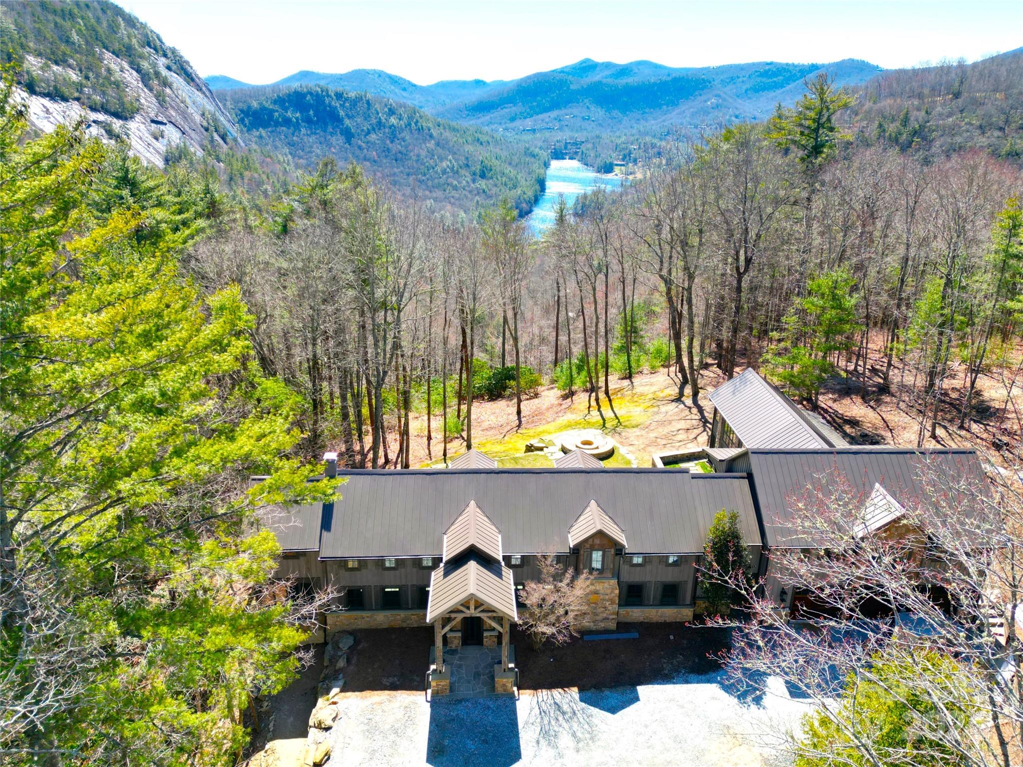 Legacy Property!! This incredible and unique mountain home was completely remodeled & expanded in 2024 and enjoys perhaps the best setting in Western North Carolina, with incredible Views of Lake Fairfield, Bald Rock's sheer cliff & surrounding mountains from over 5 acres at 3850' elevation. An impressive architectural and private home with gentle yard, small stream and huge views from every room, featuring majestic 2 story rooms, an open staircase & catwalks throughout, plus an amazing 2 story ultra-private master suite, with large sitting area, big views, spacious loft office, huge walk-in closet, with unique bathroom spa including beautiful Tub & Steam Shower surrounded by automatically fogging and retractable windows! This home is for the discerning buyer wanting the top finishes and an amazing private setting with huge lake and mountain views! Bald Rock & Sapphire Valley Master Association Amenities. Fiber optic internet, paved & gated access with underground utilities.