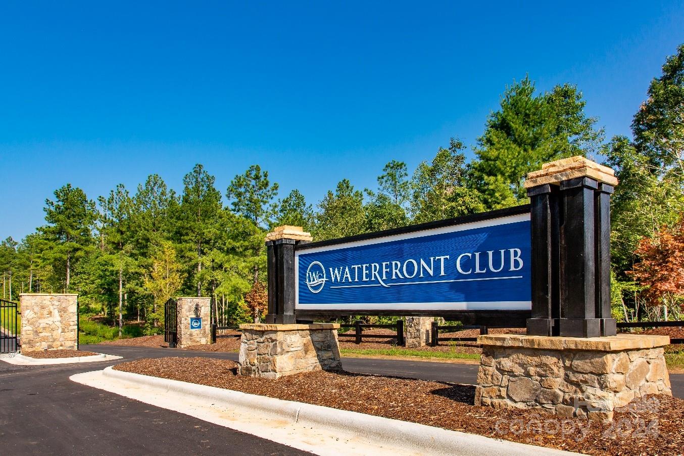Beautiful lake access, wooded lot with views in The Waterfront Club on Lake Rhodhiss. Easy build site on this private and wooded 4.37 acre lot within this beautiful lakefront community. This property can enjoy the lake from the community boat dock or the community lakefront beach area. Nearby boat ramp & minutes from I-40, Valdese, Lenoir and Hickory. The Waterfront Club offers all the amenities to enjoy the lake with direct lake access through the private dock & outdoor pavilion overlooking the water or the exclusive beachfront park with expansive outdoor timber frame pavilion, pool, stone firepit & a beautiful sandy beach for the whole family to enjoy the lake! Take a break from the water & walk the nature trails & enjoy the sweeping mountain & lake views! Waterfront Club offers an immaculate gated boulevard entrance with wide paved roads & underground utilities including water.