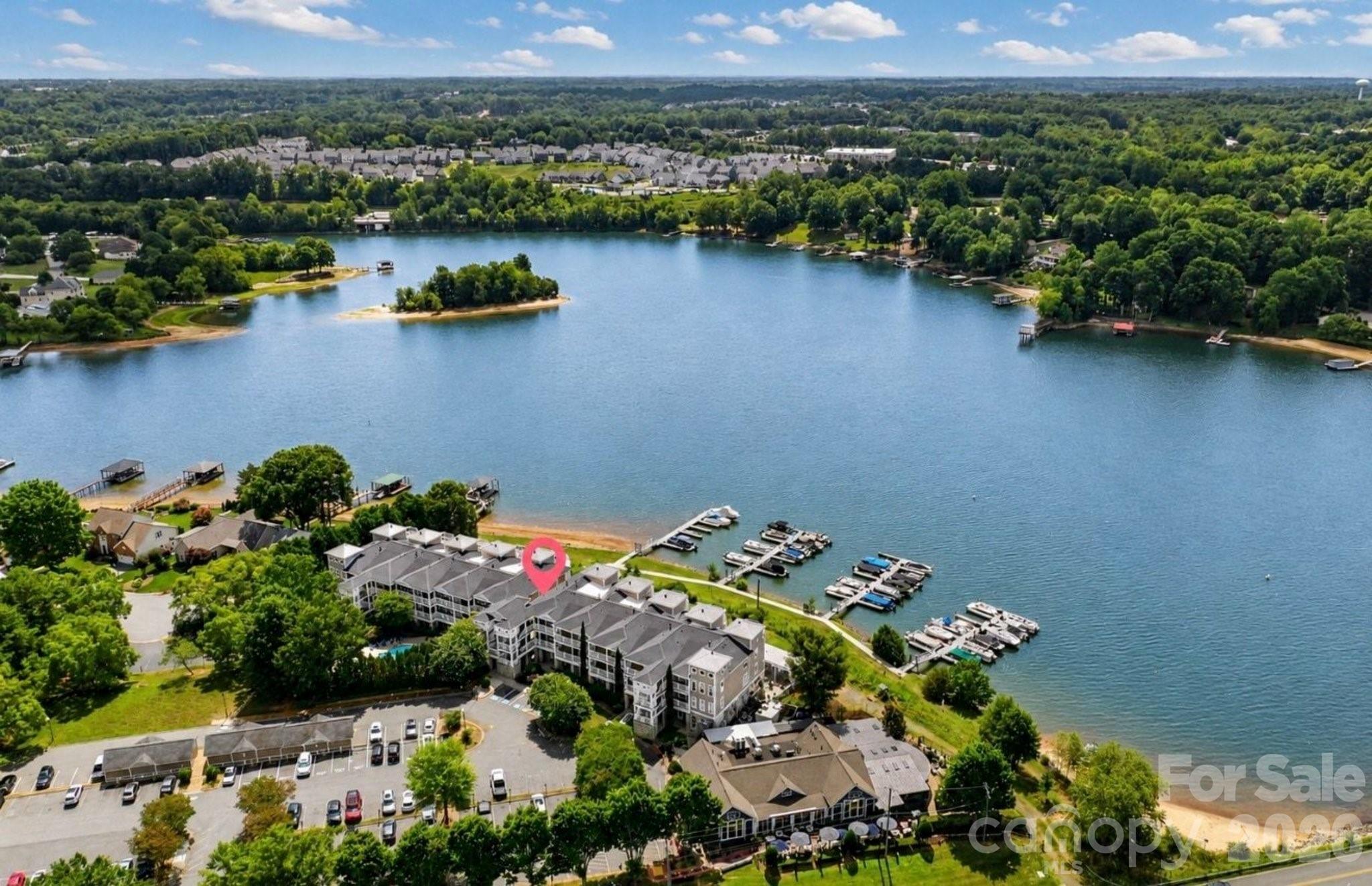 It's all about the view...and this beautifully updated end-unit delivers! This Lake Norman waterfront condominium combines breathtaking lake views, an exceptional open floor plan, and an unbeatable location just minutes from everything Mooresville has to offer! Offering three bedrooms, two full baths, and an abundance of windows that fill the home with natural light, this highly sought-after floor plan was designed to capture spectacular waterfront views from the kitchen, dining area, great room, and covered balcony.

Thoughtfully updated by the current owners, this home shows beautifully and is truly move-in ready! The well-appointed kitchen features granite countertops, a decorative tile backsplash, pantry, breakfast bar, stainless steel appliances, a gas range, and plenty of workspace for everyday living and entertaining. The adjoining dining and living areas are warm and inviting, highlighted by custom built-ins and a spectacular double-sided gas fireplace shared with the primary suite. The covered balcony becomes a natural extension of the living space, offering the perfect spot to enjoy your morning coffee, unwind after a long day, or simply soak in the ever-changing beauty of Lake Norman.

The spacious primary suite is a peaceful retreat featuring stunning lake views, private balcony access, a generous walk-in closet, and a beautifully appointed bath with dual vanities and a tiled walk-in shower. Two additional bedrooms provide flexibility for guests, family, or a home office, while the oversized laundry room offers exceptional storage and includes the washer and dryer.

Additional features include 9-foot ceilings, ceiling fans, abundant natural light, and elevator access, making everyday living both comfortable and convenient.

Residents enjoy a sparkling community pool just steps away and the convenience of two locally owned waterfront restaurants located on the ground level. Whether you're searching for a full-time residence or the perfect lock-and-leave lake retreat, you'll appreciate the low-maintenance lifestyle and unbeatable location just minutes from shopping, medical facilities, I-77, and downtown Mooresville! With its coveted end-unit location, beautiful updates, and breathtaking Lake Norman views, this is a rare opportunity to experience waterfront living at its finest!