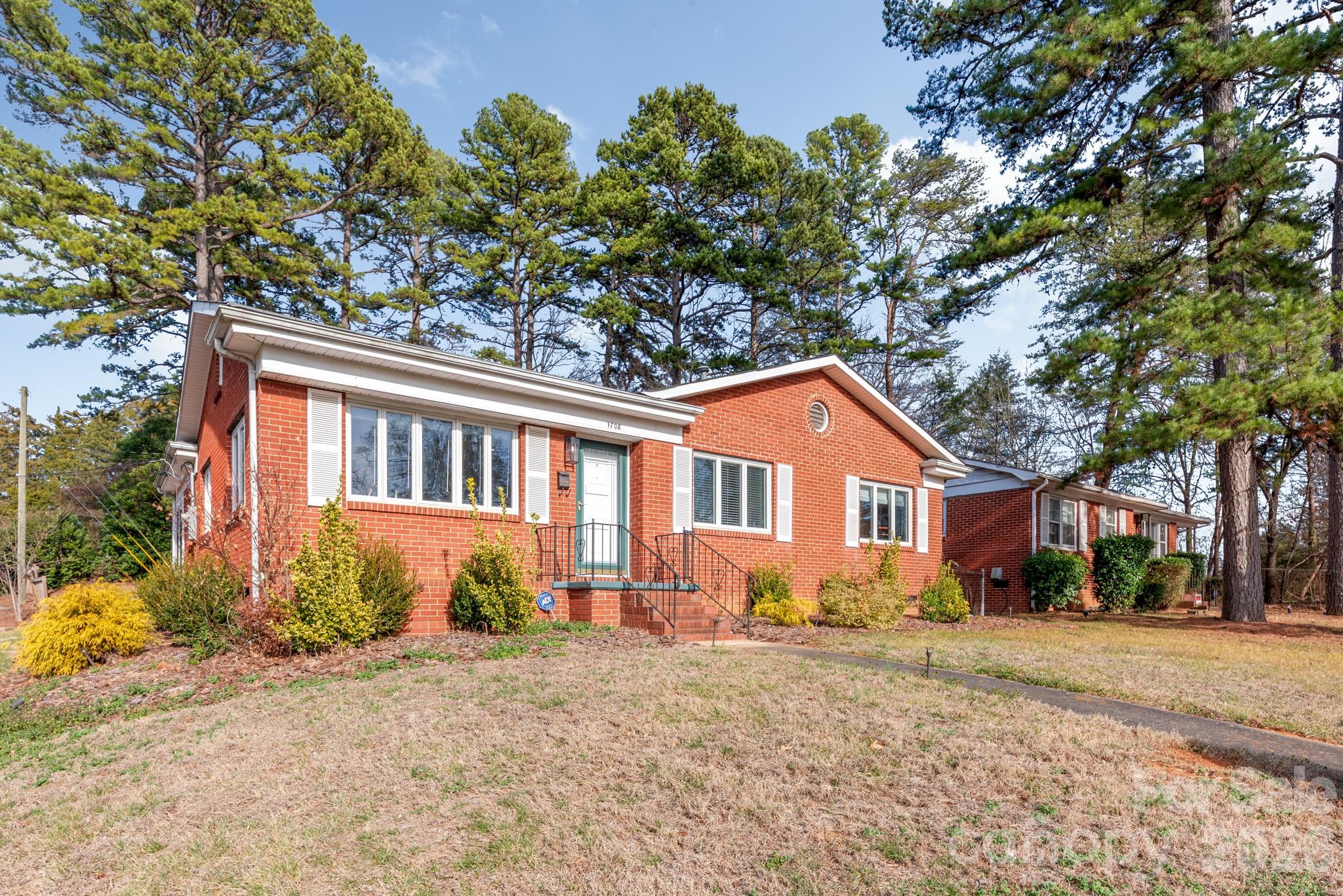 1708 Miles Court is located just a 5-minute drive to Uptown Charlotte in Historic Oaklawn Park. This well-maintained 1950’s ranch sits elevated from the street and has cute curb appeal. Enter the front door to a sunlit living room which opens to the dining room and kitchen. The paneled den and enclosed rear porch offer additional living space. Most of the house features original hardwood floors that give off a special warmth. 3 bedrooms, an updated bath and large laundry room finish off the interior of this fine home. Step outside to the backyard which features a firepit, patio and carport. 2023 Electrical Update. Other very close-by attractions include Camp North End and the Music Factory. Schedule a tour today!