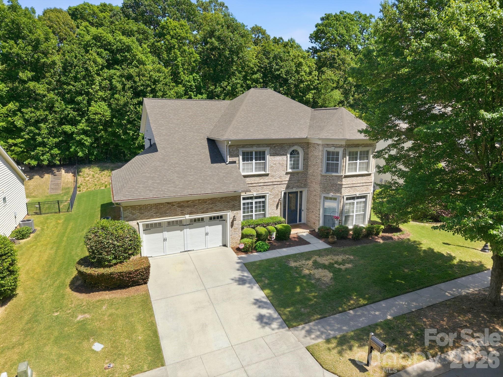 Welcome to 204 Black Mountain Drive, the kind of home that makes you want to slow down, settle in, and imagine your life unfolding here. Located in one of Fort Mill’s most desirable communities, this 4-bedroom, 3.5-bath home offers elegance, warmth, and inviting spaces designed for everyday enjoyment. From the moment you step inside, the gracious foyer welcomes you into a home filled with comfort and character. The private office and den offer flexible spaces for work, reading, or quiet relaxation, while the family room draws you in with a stunning stone fireplace, creating the perfect place to gather. The gourmet kitchen is the heart of the home, featuring granite countertops, double ovens, a generous walk-in pantry, and a bright breakfast nook overlooking the private backyard. Two screened-in porches extend the living space outdoors, offering peaceful spots for morning coffee, evening wine, or simply enjoying the view. Upstairs, the luxurious primary suite feels like a true retreat, complete with a spacious sitting area and a spa-inspired bath. Bright additional bedrooms provide comfort and flexibility for family, guests, or hobbies. With beautiful indoor and outdoor living spaces, refined details, and a setting you will love, this Fort Mill home is one you will want to experience in person.