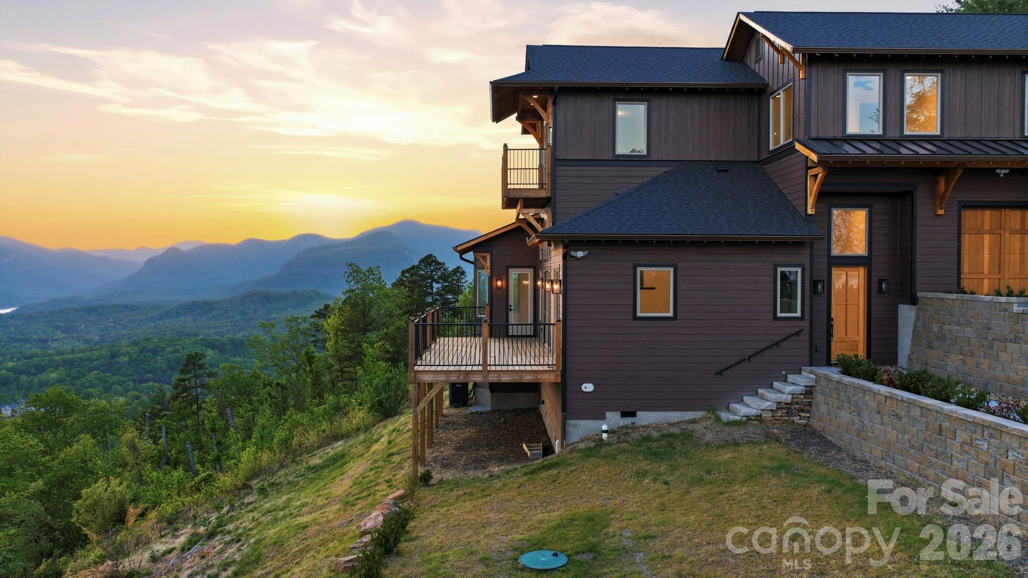 Spectacular views await you from this amazing 3 bedroom, 3.5 bath, new construction in Lake Lure NC. Tranquility awaits you in the exclusive, gated community of Vista at Bills Mountain. This stunning home (plus a bed/office/ bonus area and loft) blends modern luxury with the natural beauty of the Blue Ridge Mountains. The spacious owner's suite on the main level, open-concept living area and wall of windows allow you to take in spectacular sunset views across Hickory Nut Gorge and Chimney Rock, with layered panoramas of Bald Mountain, Rumbling Bald Mountain, Tryon Mountain and Sugarloaf Mountain. This home is equipped with a rainwater collection system. Step outside to the expansive deck or cozy up by the fireplace and soak in the peaceful mountain surroundings. Enjoy the prestigious lifestyle of Vista at Bills Mountain, featuring a grand clubhouse, fitness center with saunas, outdoor pool, tennis courts and scenic walking trails......all within a secure gated community. Perfectly located just 45 minutes to Asheville Airport, 60 minutes to Greenville-Spartanburg and 90 minutes to Charlotte. Come experience the best of Lake Lure living.....your mountain dream home awaits you! No short term rentals allowed in Vista at Bills Mountain.