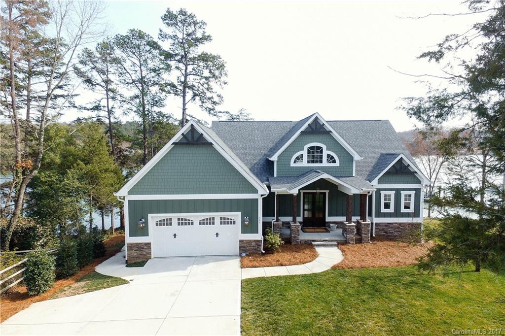 Property is owned by a Licensed SC Real Estate Agent.  Custom Waterfront Craftsmen on the most desirable street in Tega Cay!  Resort Living!  Water Views from EVERY Room!  Only 2 years old with 160 ft of shoreline, private dock on deep water.  Tons of outdoor living!  This home has all the bells and whistles!  You will fall in love with the Blue Heron that stops on the dock each morning!  Walking distance to Award Winning Schools and to Beach Club!
