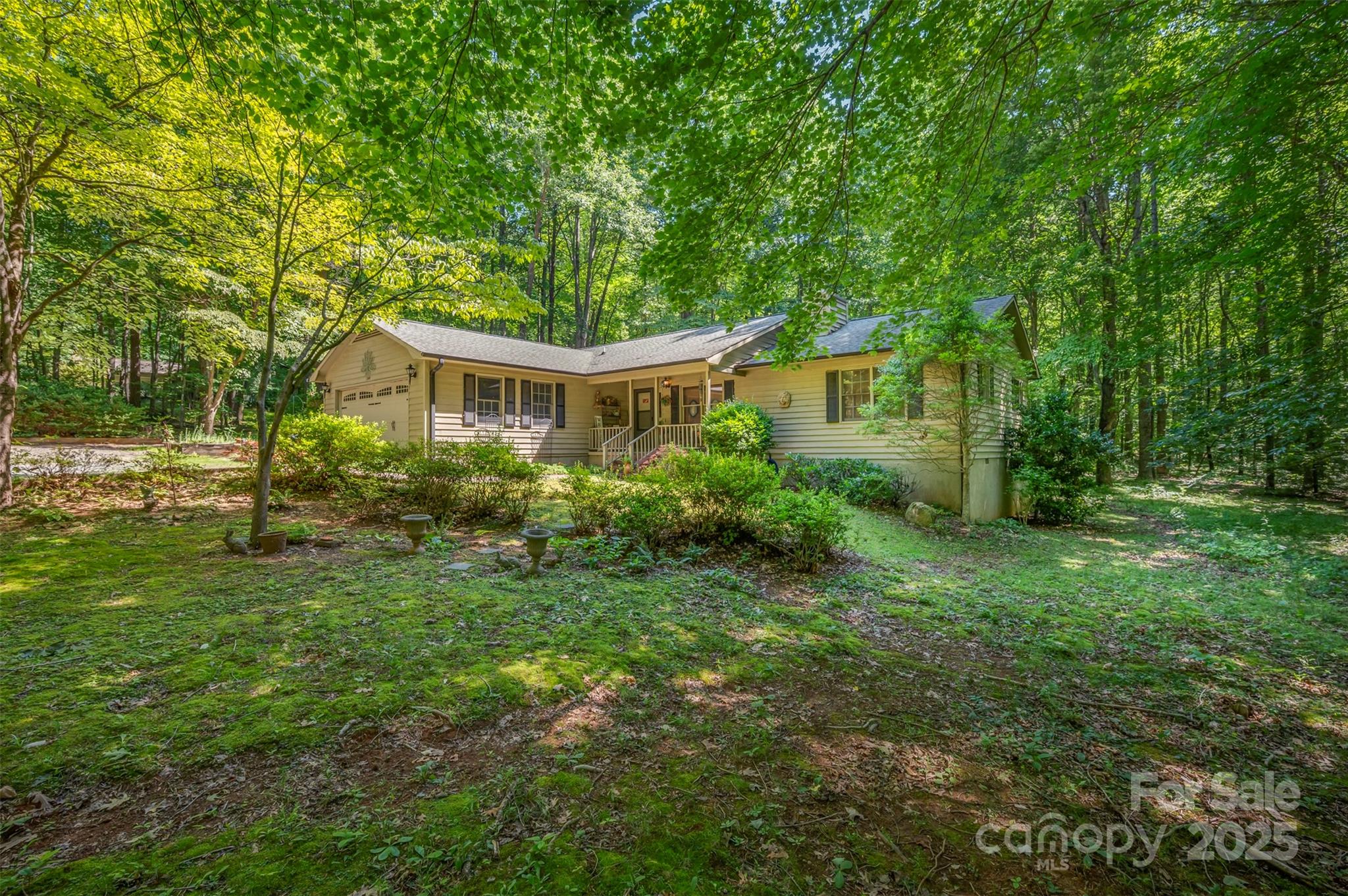 Enjoy a cozy life in the center of everything, just minutes from Tryon and Columbus, yet backed up to the Polk Memorial Gardens for permanent privacy and quiet. This three bedroom traditional home has a split floor plan, with two bedrooms on one end and the primary on the other. Hardwood floors in the main living areas and beautiful tile in the kitchen. There is no HOA. Lovely landscaping and a screened porch in back make for year-round enjoyment.