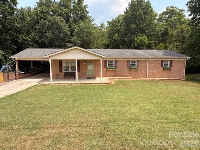 Large brick 5 br 3 ba home with updates. Beautifully updated with wooden kitchen countertop. 4 bedrooms on main with one being huge primary bedroom at end of hall with walk in closet & private bathroom. Replacement windows. Heat pump for main floor. Hardwood & luxury vinyl plank flooring on main. There is 1674 square feet in basement in addition to the 1674 on main. Basement has interior access & separate driveway with den, bedroom, kitchenette/laundry room & bathroom with shower. Ceiling height 2 inches below 7 ft in basement but has mini split for heat & a/c in finished areas & has drop ceiling that appears could possibly be raised. There is also large storage room under primary bedroom in basement. Garage in basement also. Inground pool liner only 2 years old. Pool depth from 3 ft-8 ft. Deck off carport connects to fenced in pool area. In 2028 road construction to add sidewalk beside road is planned by dot on Cajah Mtn Rd.