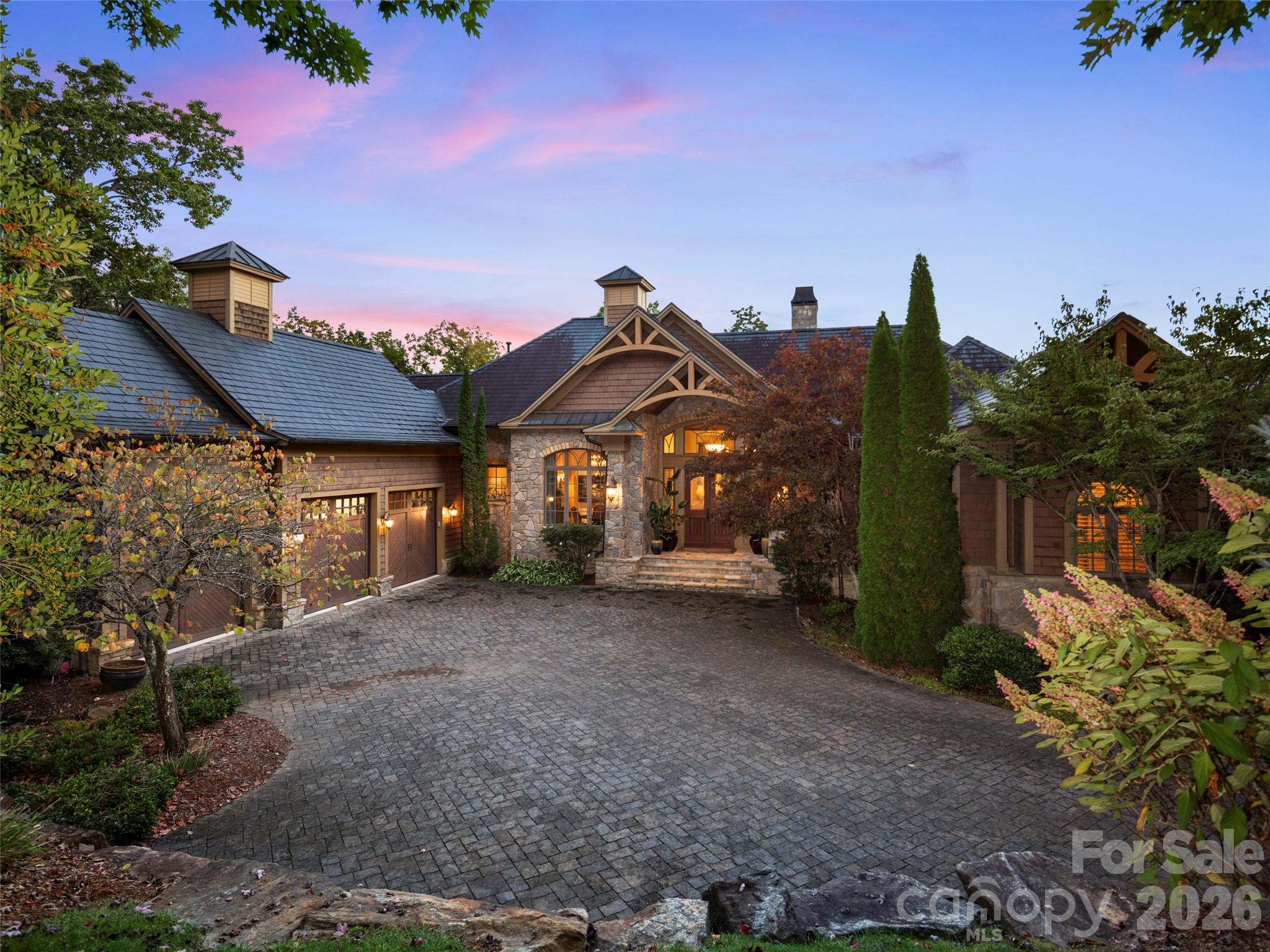 Spectacular views from this custom home located on a secluded street in The Cliffs at Walnut Cove. Extremely well appointed with high level finishes, including a gourmet kitchen, 4 fireplaces, an elevator, and an elegant primary bedroom and bath.  Enjoy cool breezes and beautiful sunsets while dining on the phantom screened porch. All living areas access covered porches with mountain and beautiful landscape vistas. The lower level features 11-foot ceilings, a game room, and an open wine room for tasting gatherings. Three ensuite bedrooms offer privacy and comfort to family or guests. An oversized three-car garage, a level driveway, and a large motor court provide safe and easy access to this home. This home is a must-see.