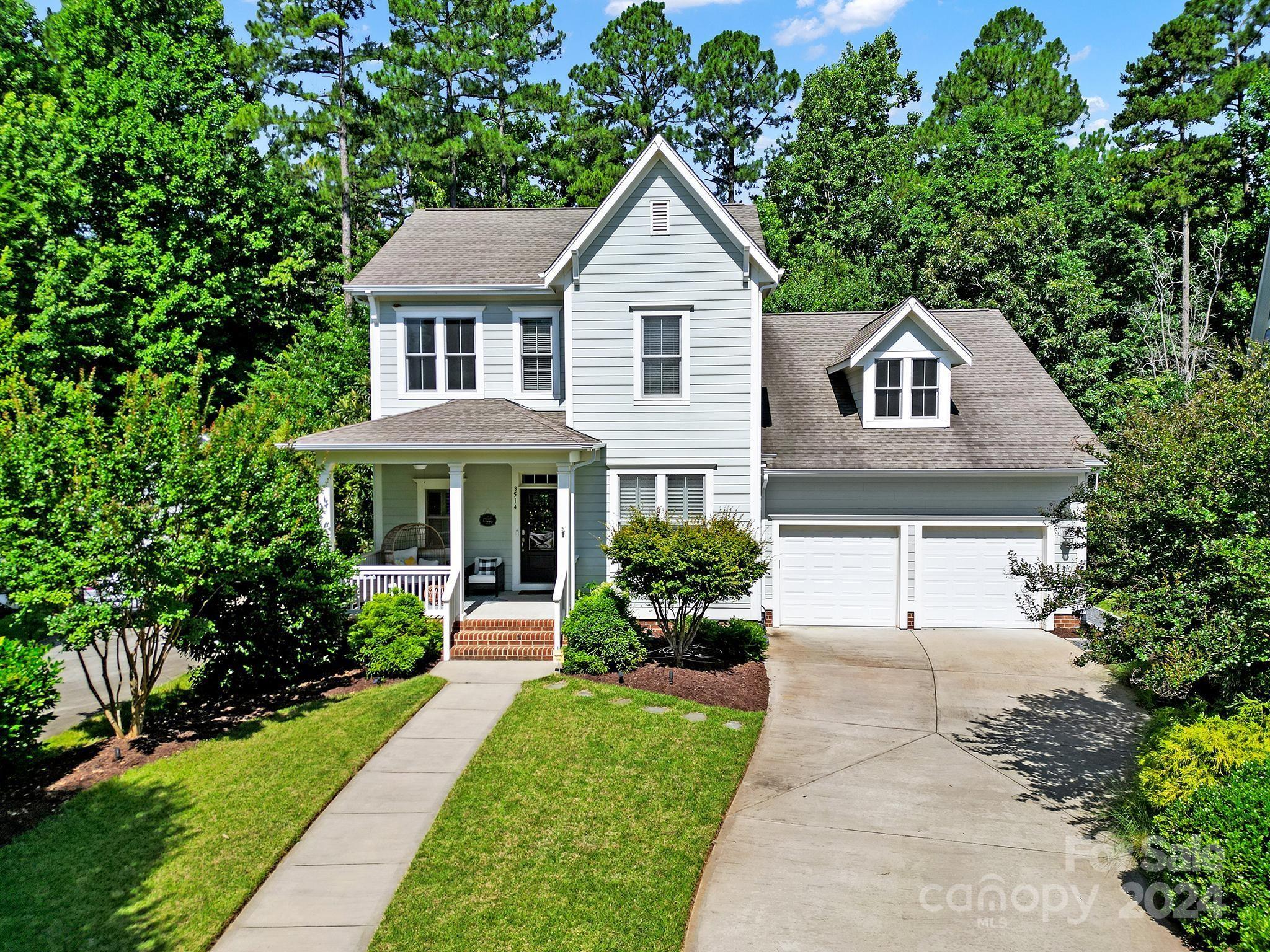 Welcome to Baxter Village, one of Fort Mill's most sought-after neighborhoods! This breathtaking home is full of design, upgrades, style & is meticulously maintained. With an open floor plan, the living, dining & kitchen areas flow seamlessly, ideal for daily life & entertaining. Upgrades include designer light fixtures, extensive wall moldings, wood floors, custom shades & soaring ceilings. The chef's kitchen has stainless steel appliances, wall oven, gas cooktop & an oversized breakfast Island. The owner suite is on the main level with a large walk-in closet & the spa like bath was just renovated. Upstairs there are 2 additional bedrooms, a spacious loft & a hall bath. Enjoy the wildlife & nature shows daily in the private wooded, fenced backyard. 2 Car Garage. Rich amenities include hiking trails, 2 pools, playgrounds, music in the park, clubs & festivals. Only 5 mins to shops & restaurants in the Village. Award winning schools. Low SC taxes. Easy drive to airport & uptown CLT.