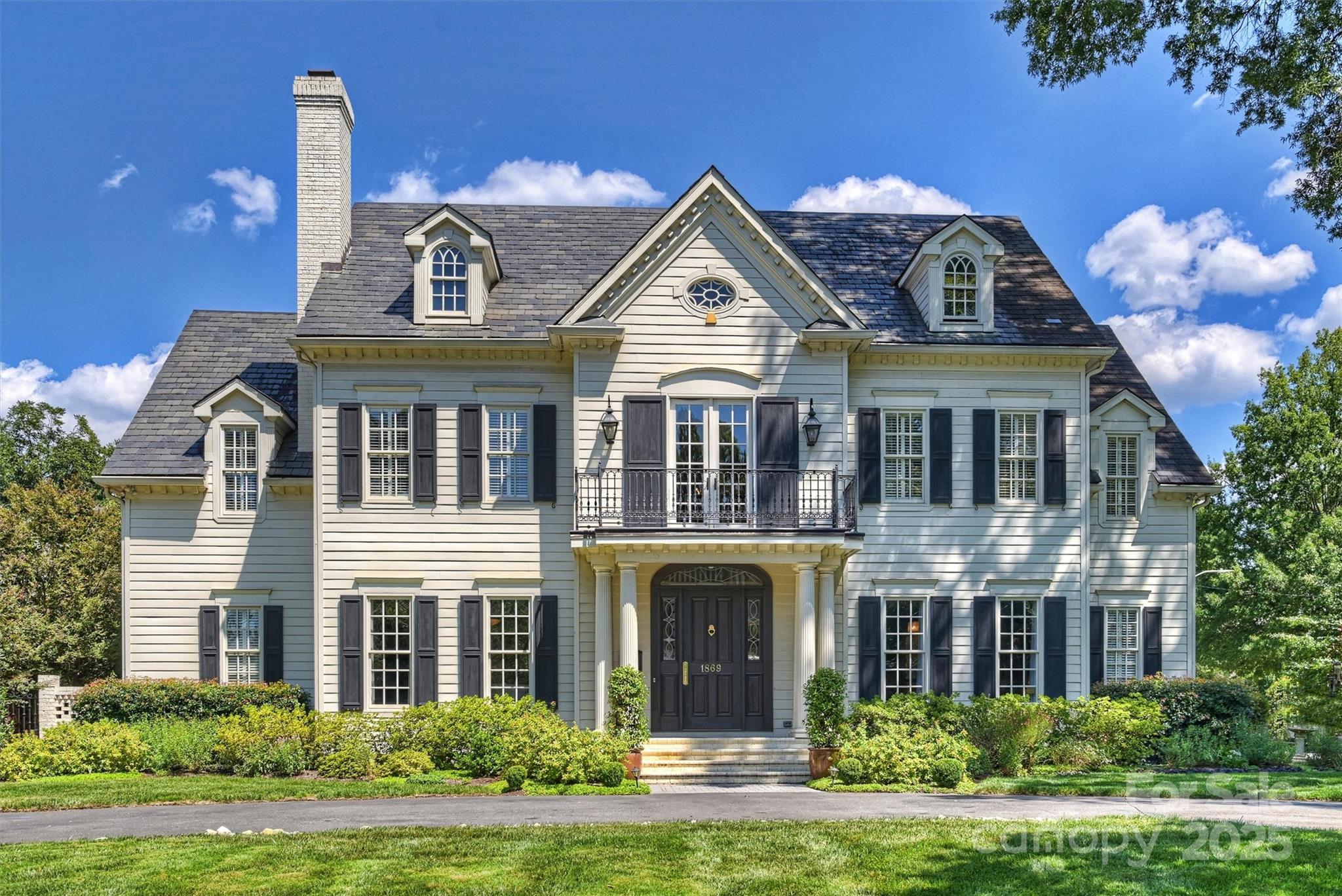 This elegantly renovated 5 bedroom, 5.5 bath home that perfectly blends comfort, style & functionality is located on the most desirable street, Queens Road West. Just minutes to Uptown and the Hospitals, with Upscale Shopping, Restaurants, Freedom Park, Greenway, & Breweries all less than a mile away. Nestled on a beautifully landscaped lot, this spacious home boasts resort style living w/ a private saltwater pool, turf backyard, garden, & 2 screened-in porches. The thoughtfully designed layout features a main-level primary suite, complete w/ spa inspired bathroom with heated towel rack and body spray feature in shower, & walk in closet (with stackable laundry hookups). The chef's custom kitchen will not disappoint with hidden refrigerated drawers, multiple dishwashers and prep stand that folds back into the cabinet in the island.  Entertaining is a breeze in the oversized great room, stately living room where on can also enjoy a drink from the bar (ice maker 2025). Enjoy a meal in the dining room, the breakfast room that feels more like a sunroom, or enjoy dining at the outside table. An elevator provides easy access to the 2nd floor w/ 3 en-suite bedrooms, Bonus rm/2nd living space w/ a kitchenette (& mobile island)& own powder room. Additional storage can be found in the walk in cedar closet next to the elevator, an oversized laundry room w/ sink, plenty of cabinets and countertop space, plus an additional walk in closet. Above the garage is the perfect space for a nanny/au pair, guests, home office, or a personal gym. With ample parking for you & your guests, this home truly meets today's modern lifestyle. Important details not to be missed: Greenspace Sealed Crawl Space System 2025, pool heater & updated electrical/technology 2025, whole home water filtration system 2024, garbage disposal 2024, 2 HVAC’s & 2 furnaces replaced 11/22, one 12/2018, Rinnai tankless water heater 2022, home generator 2020, pool resurfaced 2018, Slate roof 2001. Home Inspected and MOVE IN READY! Don't miss your chance at owning this spectacular home!