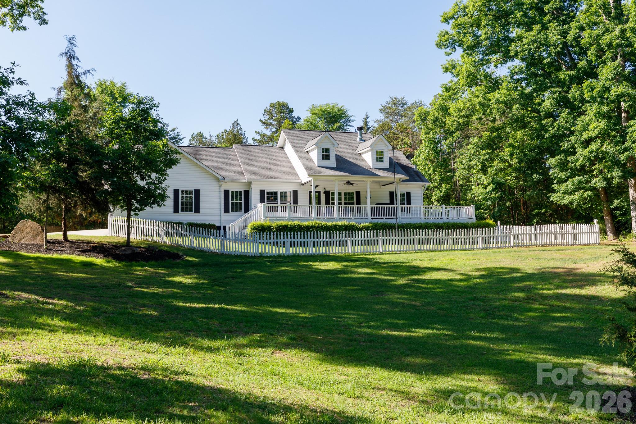 Beautiful single-story ranch home on 10 private, wooded acres in York County, SC—a rare opportunity to own a peaceful country retreat with modern upgrades. Set atop a gentle hill, this pristine, move-in ready home offers scenic views, exceptional privacy, and a long, winding paved driveway past boulders and dense forest leading to a welcoming front porch. A truly special property that stands out in York County. Featuring 3 bedrooms and 2 full bathrooms, the home offers a bright, open layout ideal for everyday living and entertaining. Built with durable 2x6 construction for energy efficiency, highlights include a heat pump HVAC system, granite countertops, cultured marble in the primary bath, and well-maintained finishes throughout. Additional features include a luxurious primary suite with double sinks, soaking tub, and two oversized walk-in closets, plus fenced yard areas, whole-house water filtration system with softener, wired workshop/shed, carport, and generator-ready setup. The usable wooded acreage offers endless possibilities—ideal for homesteading, hobby farming, gardening, recreation, or small livestock. Enjoy quiet country living just minutes from downtown York and popular local destinations. A rare blend of privacy, land, and convenience.