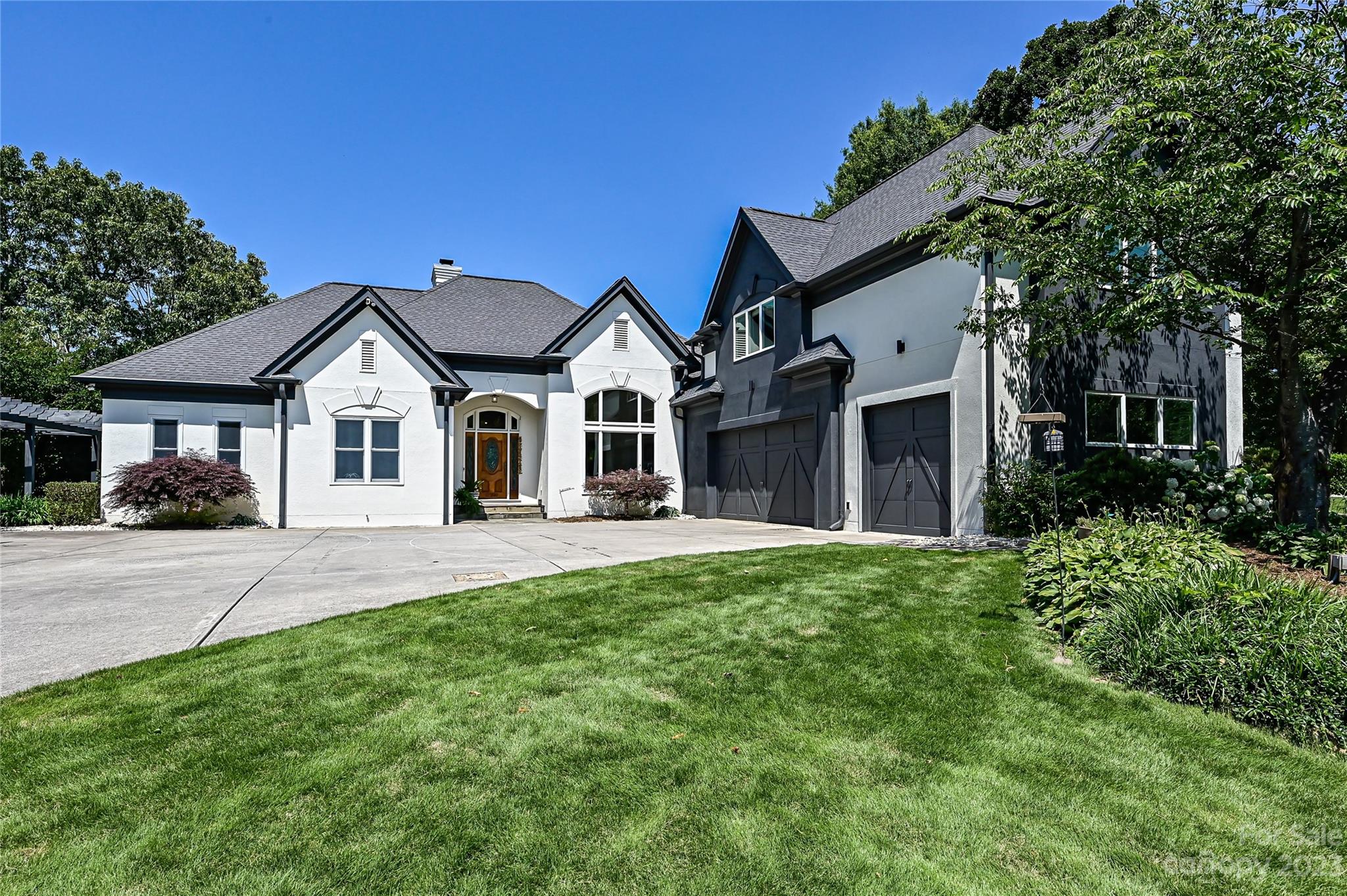 Discover the ultimate blend of Luxury and Nature in the peaceful lakefront community of Waterford Point. This one of a kind distinctive custom estate has 3 levels of exquisite lake living and is unlike any other property on the market. Nestled on a private cove with direct access to open water and surrounded by lush landscaping, an impressive exterior greets you from the beautiful gas lantern lined street and the majestic driveway. A sprawling outdoor rear covered terrace offers panoramic views with a sparkling heated pool, spa, and private boat dock creating the ultimate outdoor experience for endless summer fun and resort-style living all year long. Soaring ceilings, a wall of sliding doors and windows highlight the interior perfect for gatherings with a tremendous chef's kitchen. The lake level is perfect for entertaining family and friends with a recreational room, bar with mini kitchen and the private backyard oasis with built-in grill, bar, fire-pit and relaxing covered porch.