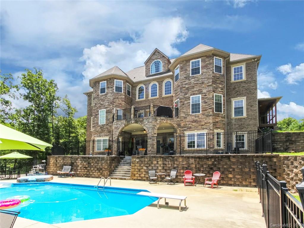 Lake Life on LKW. Seller offering $25K in Flex money at closing** Large waterfront estate w/ over 9000+ sq. ft. living space. 3 car courtyard garage & additional parking. 2.14 acre lot w/ 195' shoreline. In-ground salt water heated pool, hot tub, boat dock, outdoor terrace, grotto-style back porch. Master w/ sitting room on main. Huge bonus room, loft and rec areas, large bedrooms and bathrooms. Large, finished walk-out basement w/guest suite & full kitchen. Scenic views from most rooms. No HOA.