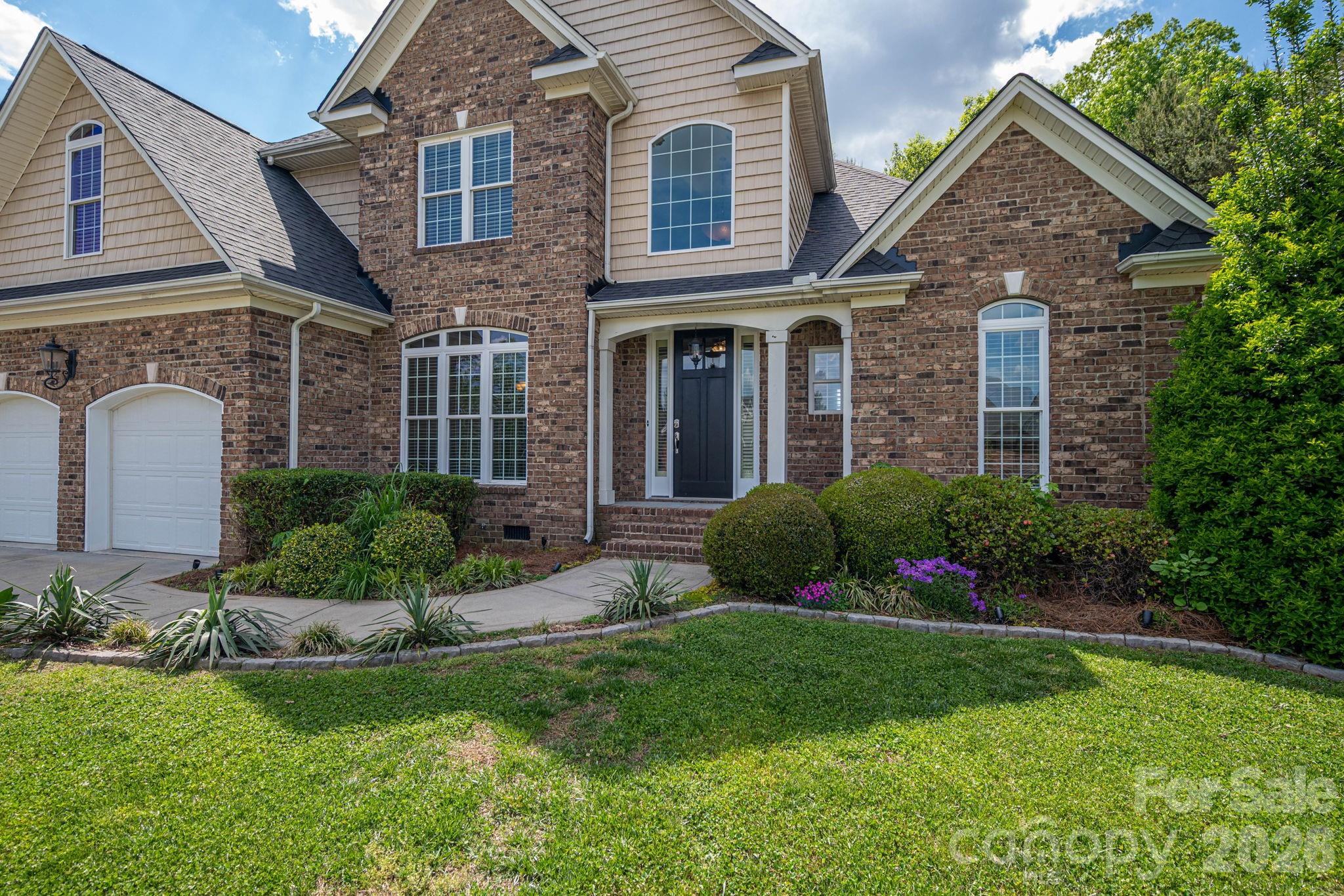 Take a look at this stunning estate located in the prestigious gated community of Old Course in Cramerton. Perfectly positioned along the 3rd fairway of Cramer Mountain Country Club, this stately home offers exceptional curb appeal and one of the most impressive architectural designs in the neighborhood. As you turn onto St. Andrews Court, the home’s presence immediately captures your attention.

Step inside the grand foyer and you’re welcomed by beautiful hardwood floors, soaring vaulted ceilings, and an elegant staircase. The spacious great room features vaulted ceilings, a handsome gas-log fireplace, and an open-concept layout ideal for both everyday living and entertaining.

The kitchen is truly a culinary dream, centered around a large island with classic chandeliers, granite countertops, a deep sink with disposal, and bar seating for gathering with family and friends. Custom white cabinetry provides abundant storage and perfectly complements the stainless steel appliance suite. Just off the kitchen, a cozy keeping room/den with its own fireplace and expansive windows fills the space with natural light, creating a warm and inviting atmosphere for year-round enjoyment.

The primary suite is generously sized and features brand-new carpeting, tray ceilings, and beautiful windows. The en suite bathroom is equally impressive, offering a soaking tub, separate tiled shower with glass doors, a large double vanity, vaulted ceilings, and an expansive walk-in closet.

Upstairs, the grand staircase with wrought iron spindles leads to three spacious bedrooms, all with new carpet, fresh paint, and walk-in closets. A well-designed Jack-and-Jill bathroom provides both convenience and privacy.

Outdoor living is just as impressive. The backyard is a true retreat, featuring a large deck that has been recently solid-stained and enhanced with ambient string lighting. A covered section leads down to a private concrete patio with a 7-person hot tub—perfect for relaxing or entertaining.

This home also offers access to the exceptional amenities of Cramer Mountain Country Club, including golf, tennis courts, pools, and fine dining.

Recent updates include fresh interior paint, all-new carpeting, and a brand-new roof installed last month. This home is truly move-in ready and meticulously maintained.

Schedule your private showing today and experience everything this incredible property has to offer.