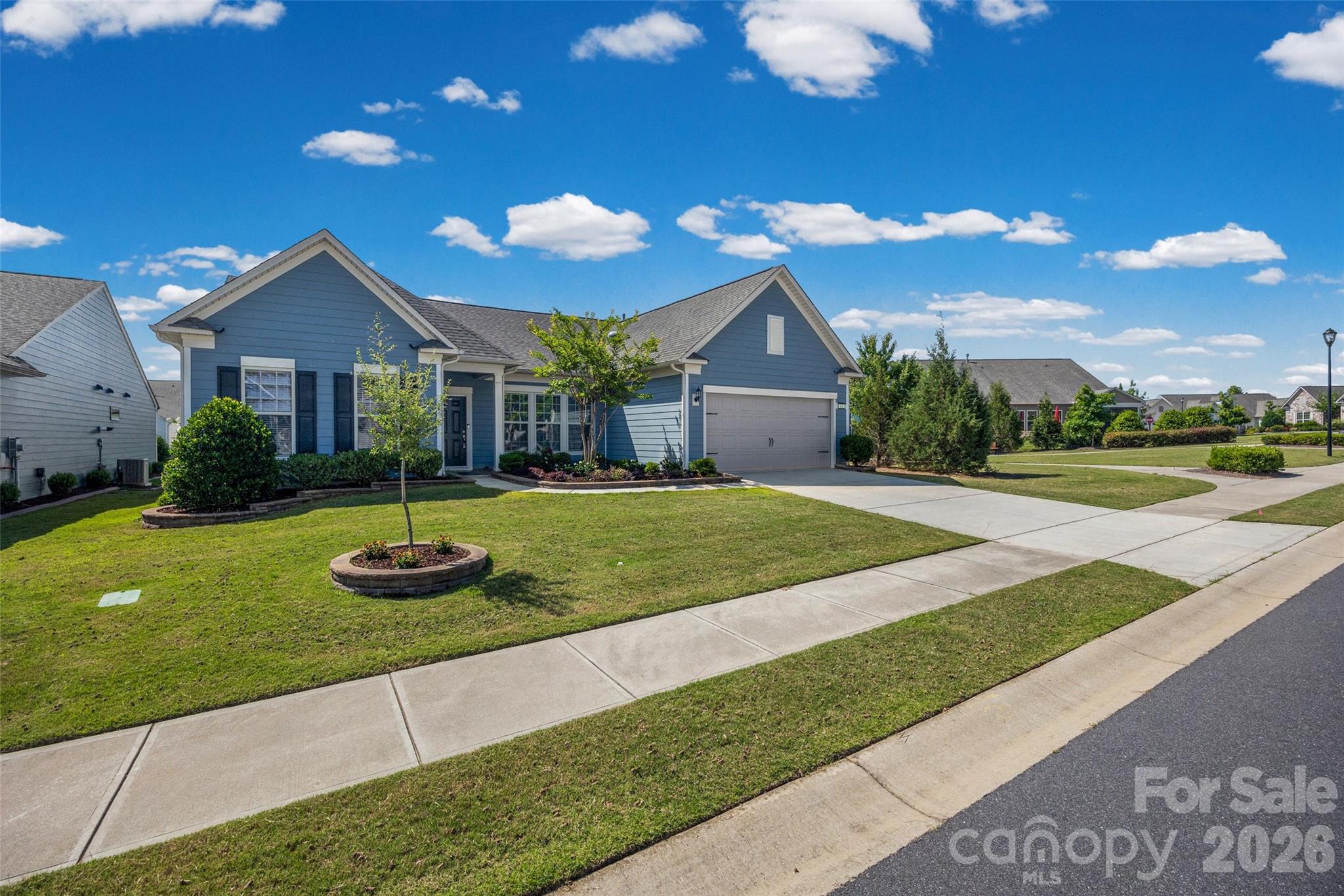 Discover the joy of low-maintenance living in the Award-winning Carolina Orchards 55+ neighborhood. This beautifully designed and freshly repainted 2,800+ square-foot Tangerly Oak model offers two main-level private primary suites. The open-concept kitchen, complete with upgraded appliances and a gas range, flows effortlessly into the spacious living and dining areas—perfect for gatherings, celebrations, and everyday relaxation.
A generously sized office/study with French doors provides the ideal space for reading, hobbies, or working from home. Just off the main living area, an inviting sunroom leads to a three-season porch, creating a peaceful retreat for morning coffee, afternoon naps, or nurturing your favorite plants.
A Pre-Listing home inspection has been completed, and any items found have been repaired or replaced. Windows with broken seals are under warranty and have already been ordered to be replaced. Interior of home has been freshly painted. The irrigation system has had its annual service, and a local landscape company has planted fresh flowers/landscaping.
With single-level living, abundant natural light, and extra storage in the two-car garage with an additional golf cart garage, this rare home offers both comfort and convenience in a vibrant 55+ community. Opportunities like this don’t come along often.