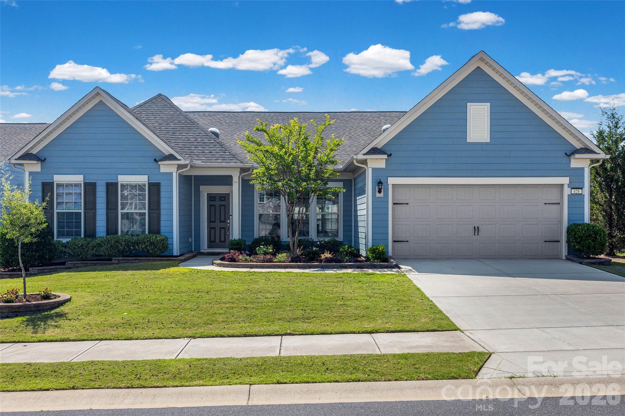Discover the joy of low-maintenance living in one of the most desirable villages within Carolina Orchards. This beautifully designed and freshly repainted 2,800+ square-foot Tangerly Oak model offers two main-level private primary suites. The open-concept kitchen, complete with upgraded appliances and a gas range, flows effortlessly into the spacious living and dining areas—perfect for gatherings, celebrations, and everyday relaxation.
A generously sized office/study with French doors provides the ideal space for reading, hobbies, or working from home. Just off the main living area, an inviting sunroom leads to a charming three-season porch, creating a peaceful retreat for morning coffee, afternoon naps, or nurturing your favorite plants.
A Pre-Listing home inspection has been completed, and any items found have been repaired or replaced. Windows with broken seals are under warranty and have already been ordered to be replaced. Interior of home has been freshly painted. The irrigation system has been repaired and serviced, and a local landscape company has planted fresh flowers/landscaping.
With single-level living, abundant natural light, and extra storage in the two-car garage with an additional golf cart garage, this rare home offers both comfort and convenience in a vibrant 55+ community. Opportunities like this don’t come often.