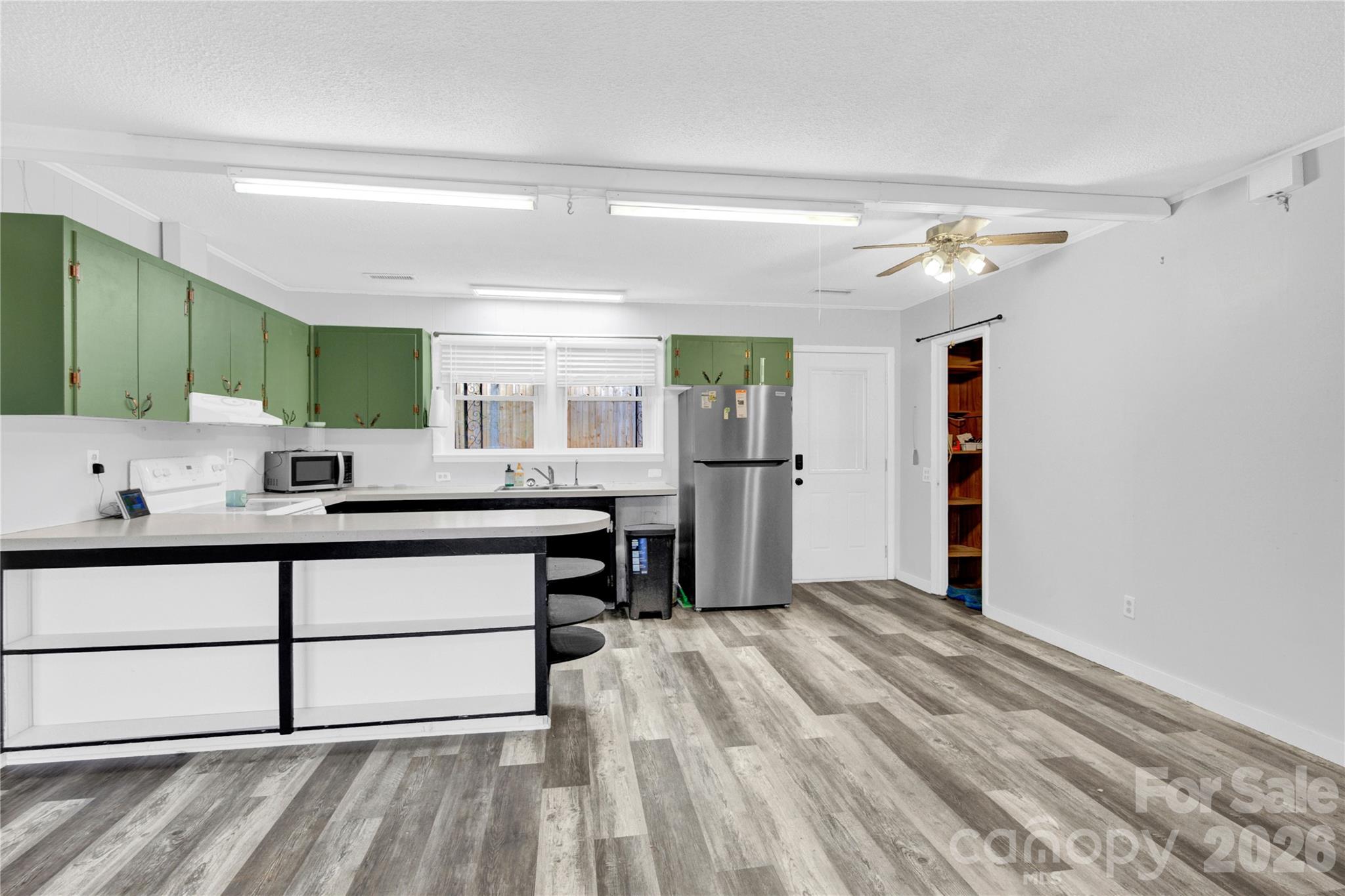**MOTIVATED SELLER!** TWO KITCHENS, TWO ENTRANCES, DUPLEX OPTION, MOTHER-IN-LAW SUITE, FLEXIBLE SPACE. 
This home is a place that offers comfort, privacy, and flexibility, setting on a private .86 acre lot surrounded by mature trees giving you a sense of peace and quiet.  The moment you walk in, you'll notice the fresh paint and LVP flooring throughout the home giving you an updated and clean look ready for you to make it your own.  What truly makes this home special is the versatility it offers with two entry points and two kitchens ready for your families needs, a guest room set up, or use it as a duplex and make additional income. Located just minutes from Hwy 150 and close proximity to Lake Norman access, you'll enjoy the perfect balance of quiet living and convenience.