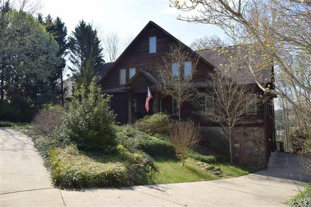 Beautiful Rustic Style Home made of Cedar Siding and Stone with seasonal Lake Hickory Views!  Lots of character with exposed beams, cathedral ceiling and open spaces separated by wood columns.  Two sided stone fireplace.  Gracious Living room with cathedral ceiling open to Dining area and Kitchen.  Office area off of the Foyer.  Main level master bedroom suite.  2 bedrooms upstairs with a loft and latter access to attic storage.  Large deck across the back of the home with a sunken hot tub.  This house is great for entertaining!
