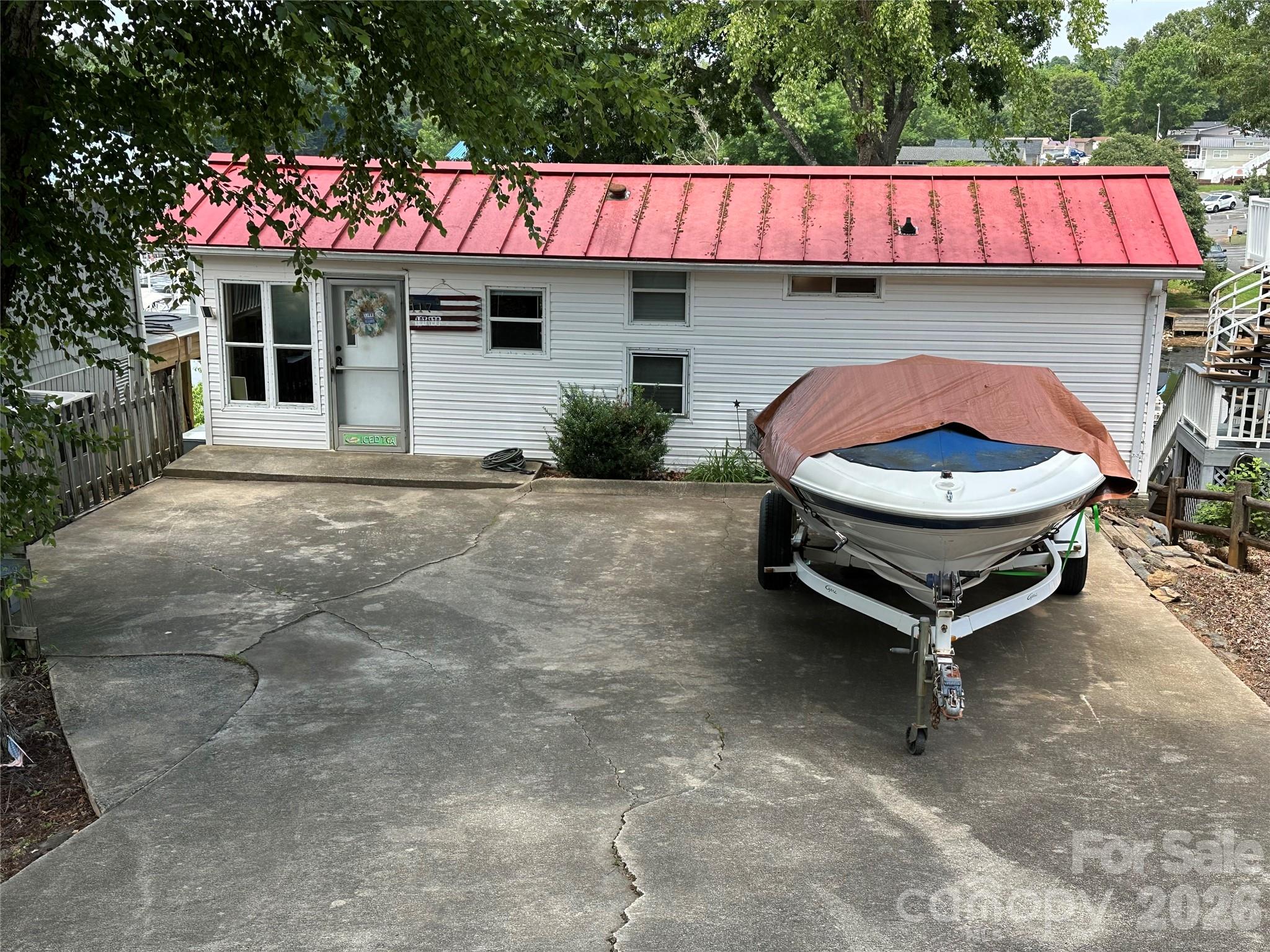 Waterfront Retreat at Badin Shores Resort! This charming 4-bedroom, 1-bath waterfront park model home with a spacious room addition and screened porch offers spectacular views of the marina and boat slips. Watch boats come and go all day for endless entertainment. Inside, enjoy the convenience of full-size appliances, including a stack washer and dryer. With direct access to the resort’s waterfront boardwalk, you’re just steps from the action. The home provides ample space to host family and guests, plus fantastic storage for water toys—or convert it into an outdoor hangout for games and fun. Take advantage of the resort’s top-notch amenities, including a swimming pool, fishing pier, sandy beach, picnic pavilions, playgrounds, basketball courts, putt-putt, and more. Whether you're looking for adventure or relaxation, this is the perfect place to embrace the waterfront lake life. Don’t miss this incredible opportunity to own a slice of paradise!
