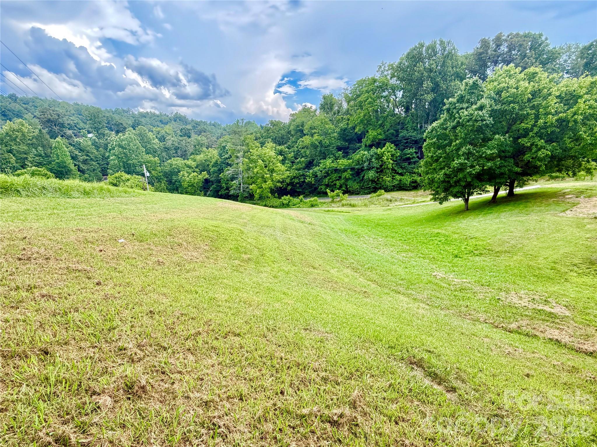 Escape to the peaceful beauty of the mountains with this inviting 2.17-acre property offering the perfect blend of open space and natural privacy. The gently rolling lower portion features an established house pad, along with an existing well and septic system, making it an excellent foundation for your dream home.

Venture up to the semi-wooded upper section providing additional possibilities for a second home. Whether you're dreaming of growing your own vegetables, a hobby farm, space for chickens, or simply room to enjoy the outdoors, this unrestricted-feeling property offers the flexibility to create the lifestyle you've been imagining.

Located just outside the welcoming community of Weaverville, you'll enjoy the peaceful charm of country living while remaining just minutes from local shops, restaurants, and all the culture, dining, and entertainment that Asheville has to offer.

If you've been searching for open skies, fresh mountain air, and a place where your dreams can take root, this beautiful property is ready to welcome you home.