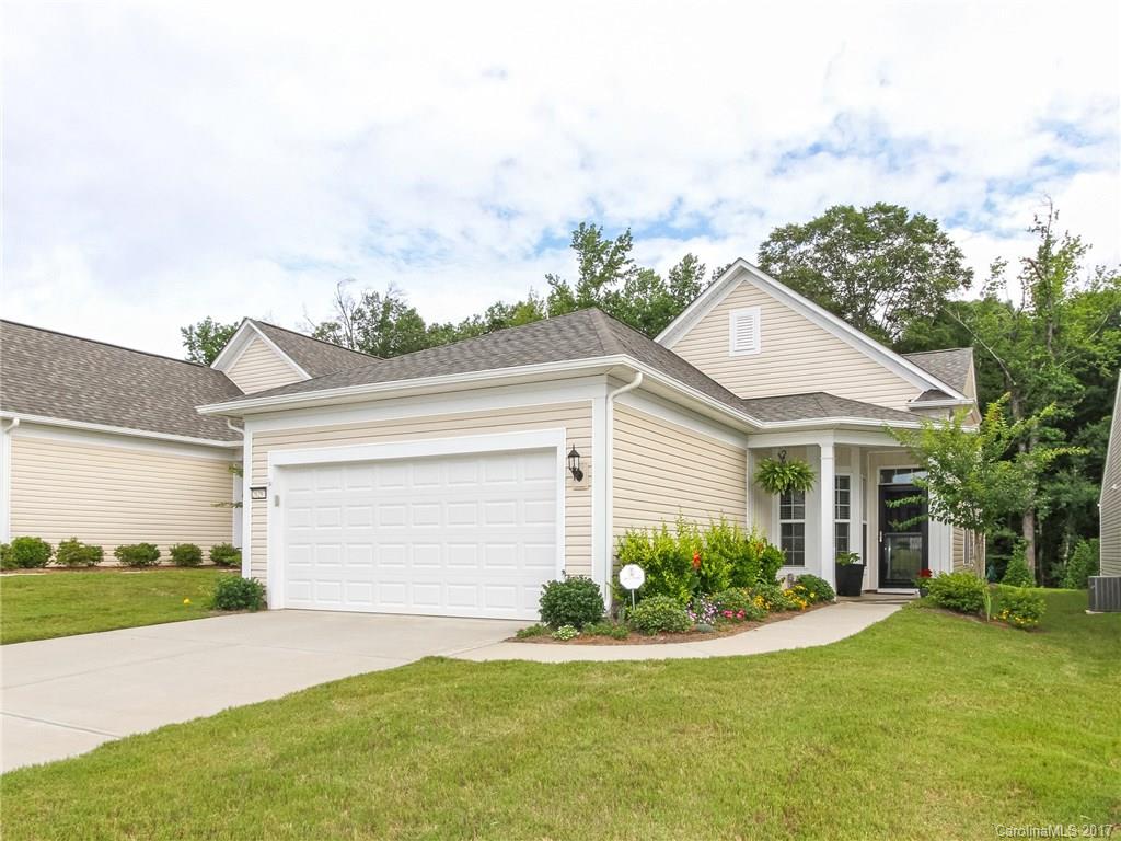 Like-new Pine Spring model w/ screened porch & wooded views. The open floor plan includes a rear kitchen that has direct access to the adjacent great room & dining room. A screened porch leads to the landscaped rear yard w/ irrigation system.  The master suite pleases w/ its tray ceiling, custom walk-in closet with built-ins, and attached bath that includes dual sinks & an oversized shower w/ tile surround. Experience easy living in this 55+ active adult community- Sun City Carolina Lakes!