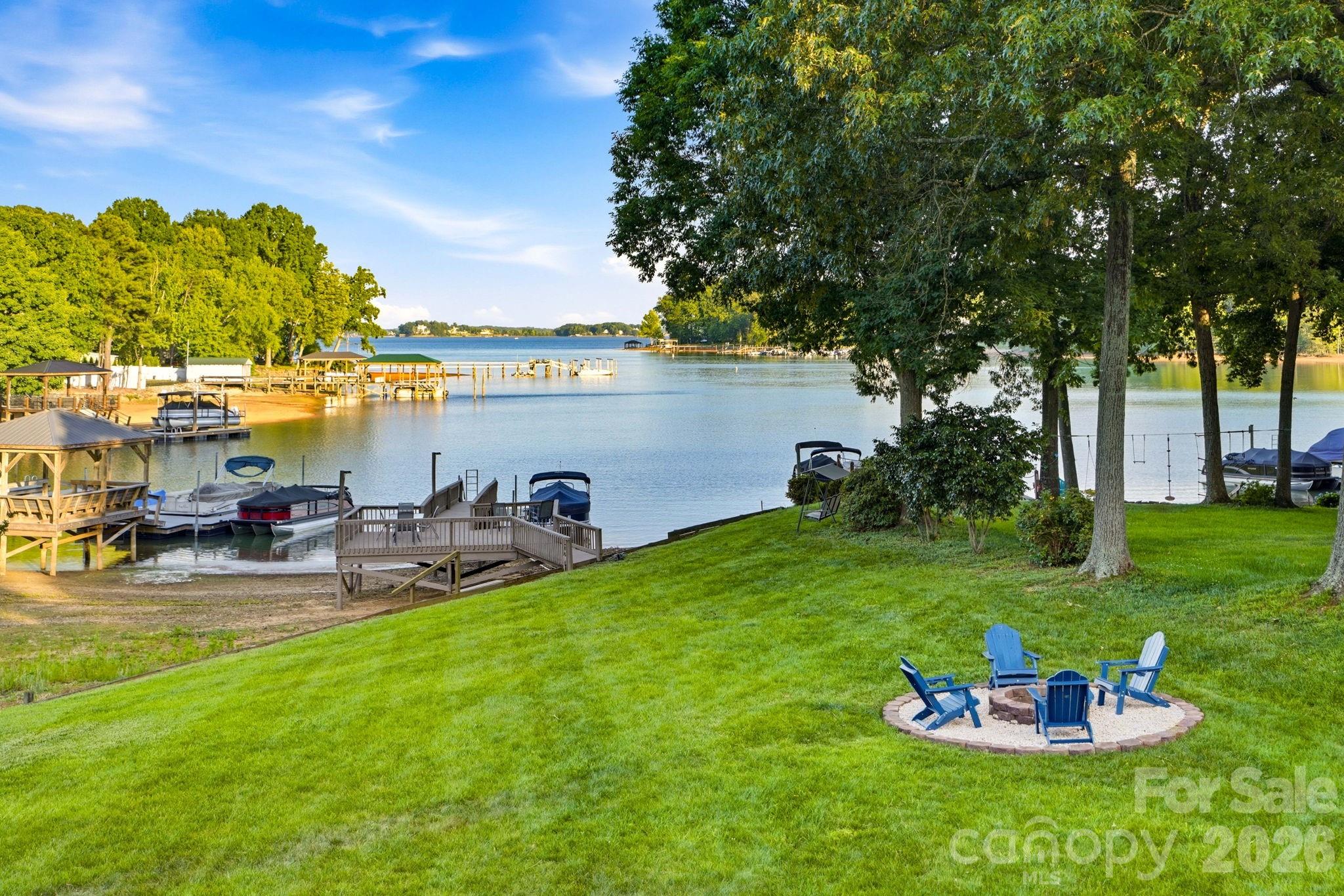 **PRICE IMPROVEMENT AT THIS EXCEPTIONAL PROPERTY FEATURING LONG RANGE VIEWS AND A PRIVATE DOCK**  EXPERIENCE WATERFRONT LIVING ON LAKE NORMAN with this beautifully updated, fully furnished 5-bedroom, 4-bath home in desirable Denver, NC. This turnkey property is ideal as a full-time residence, cozy vacation retreat, or income-producing short-term rental opportunity. Designed to comfortably accommodate large gatherings and overnight guests, the flexible floor plan offers space for 12+ guests along with multiple indoor and outdoor entertaining areas.

Enjoy peaceful mornings overlooking the water, long-range lake views, deep water access, and endless opportunities for boating, swimming, relaxing, and entertaining. Interior highlights include updated kitchen and bathrooms, tile and luxury vinyl plank flooring, two spacious primary suites including one on the main level, large gathering areas with natural stone fireplaces on both the main and basement levels, and an impressive wall of sliding glass doors across the rear of the home creating seamless connection to the outdoor living spaces and lake views.

Outdoor living is a centerpiece of the property with a large wraparound deck overlooking the water, covered lower patio, private upper-level primary suite deck, fire pit area, flat usable yard, and an updated dock with space to lounge and dine lakeside. Additional features include a one-car garage, space for RV parking, a bunk-room in the finished basement and convenient access to nearby shopping, dining, marinas, and everyday conveniences.

The property conveys fully furnished and has been thoughtfully positioned for immediate short-term rental success with operational setup guidance and property management introduction available. Rare opportunity to own a move-in ready waterfront property with exceptional versatility and strong investment potential on Lake Norman. See agent remarks for additional investment information and pro forma details, as well as a list of recent updates and improvements.