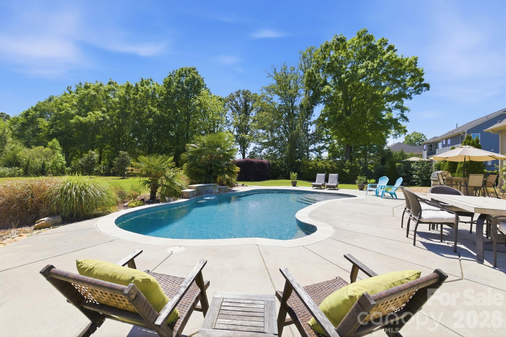 Think it's impossible to find over an acre of land just steps from the Ballantyne border, complete with an inground pool and a primary bedroom on the main floor? Think again. 5040 Barcroft Drive is the home you've been dreaming about and it's finally here.

From the moment you step inside, this home impresses. An open floor plan bathes every room in natural light, while a stunning coffered ceiling anchors the great room with architectural elegance. The spacious dining room was made for memorable holiday gatherings and dinner parties alike. At the heart of the home, the chef's kitchen features a large center island, a generous pantry, and a dedicated laundry room so thoughtfully designed that your friends and neighbors will be openly envious.

The main floor delivers rare flexibility with three bedrooms, including a truly exceptional primary suite — the bedroom is expansive, the bathroom spa-worthy, and the closet a dream. Upstairs, a fourth bedroom, a bonus room, and a flex/storage space give you every option to grow, work from home, or create the spaces your lifestyle demands.

Outside, your private oasis awaits. Dive into summer in your own backyard pool and unlike most pool properties where the water swallows the yard whole, this 1.24-acre lot stretches on beautifully, leaving ample room for gardens, play, entertaining, and whatever your imagination conjures.
All of this, and you'll enjoy the significant advantage of low South Carolina property taxes, a benefit that puts more money back in your pocket every single year.

The location is just as impressive as the home itself. Families will love the short walk to Harrisburg Elementary School and Harrisburg park and recreational soccer fields. And some of the area's best dining, shopping, and nightlife is available just 10 minutes away at the fabulous new Ballantyne Bowl.

Homes like this don't come along often and they certainly don't stay available for long. Schedule your showing today. This is the one you've been waiting for!